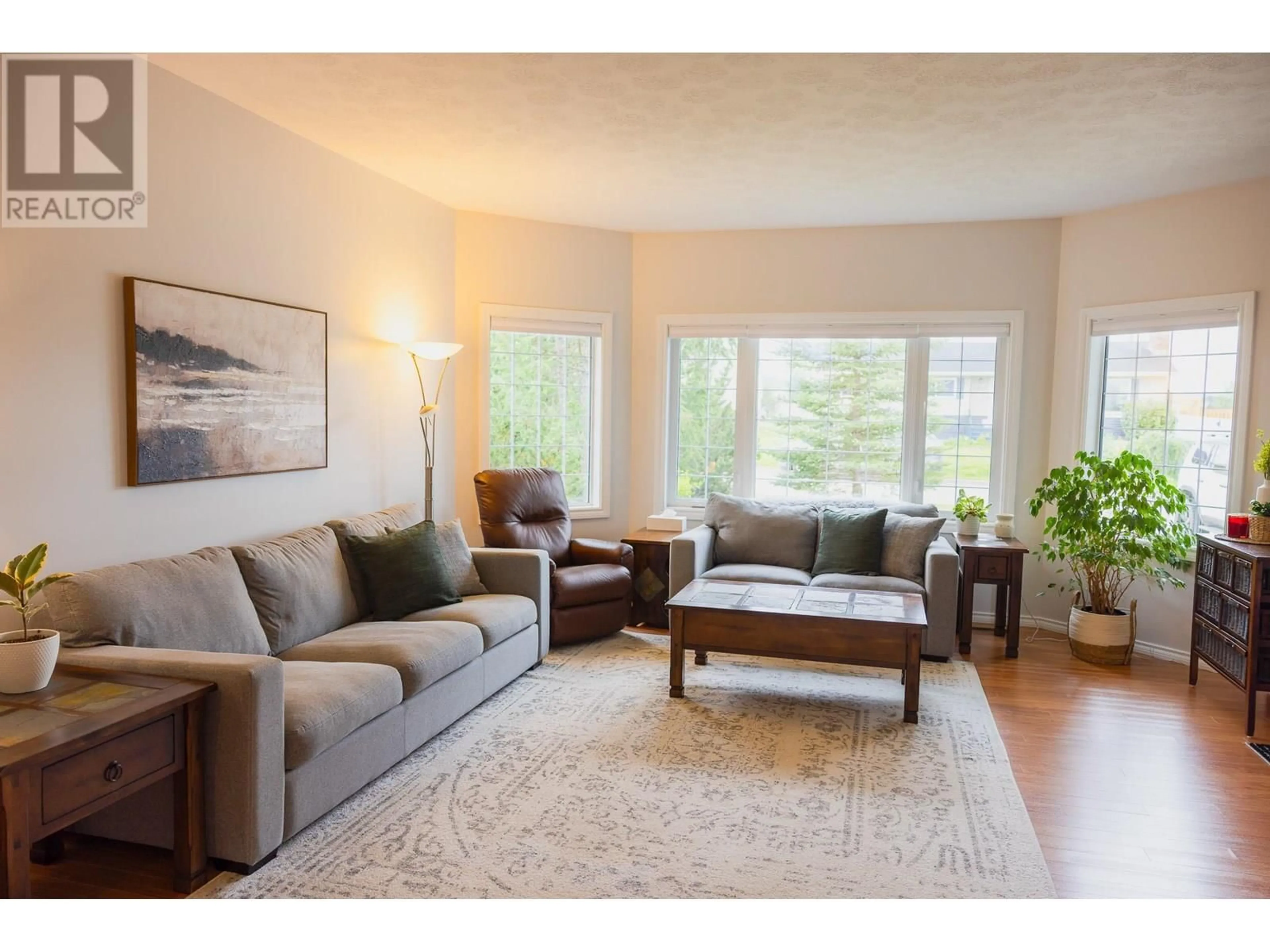 Living room with furniture, wood/laminate floor for 1812 110 AVENUE, Dawson Creek British Columbia V1G0A3
