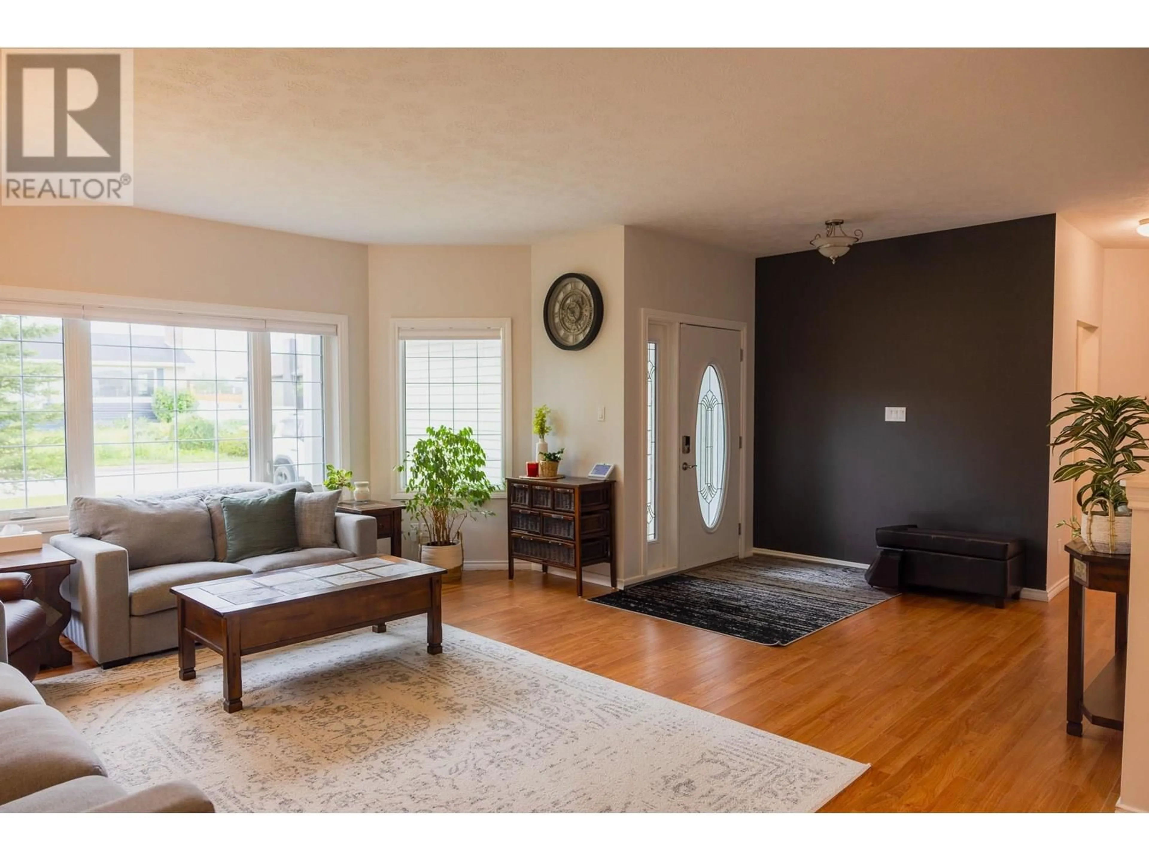 Living room with furniture, wood/laminate floor for 1812 110 AVENUE, Dawson Creek British Columbia V1G0A3