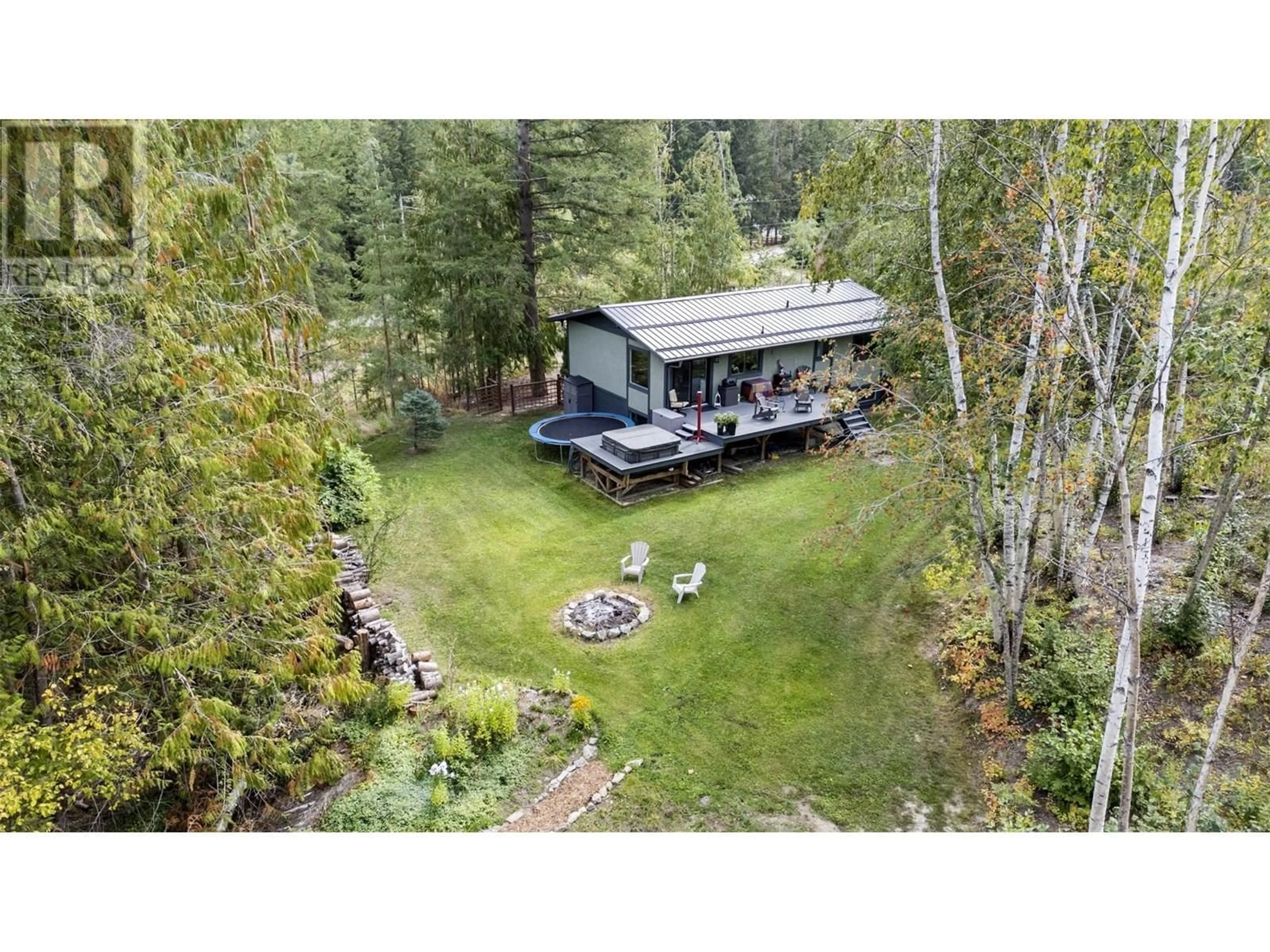 A pic from outside/outdoor area/front of a property/back of a property/a pic from drone, forest/trees view for 4451 42 STREET NORTHWEST, Salmon Arm British Columbia V1E3A7