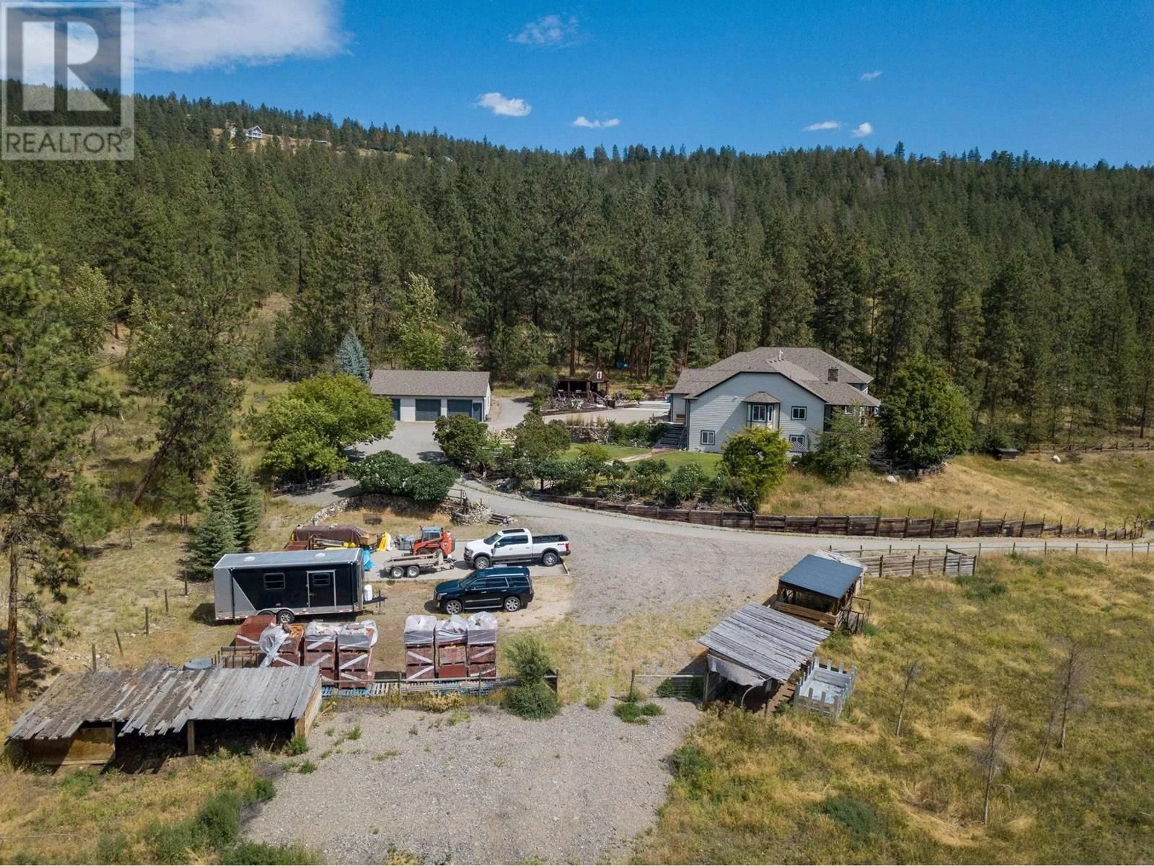 A pic from outside/outdoor area/front of a property/back of a property/a pic from drone, mountain view for 5955 POSTILL LAKE ROAD, Kelowna British Columbia V1X7V3