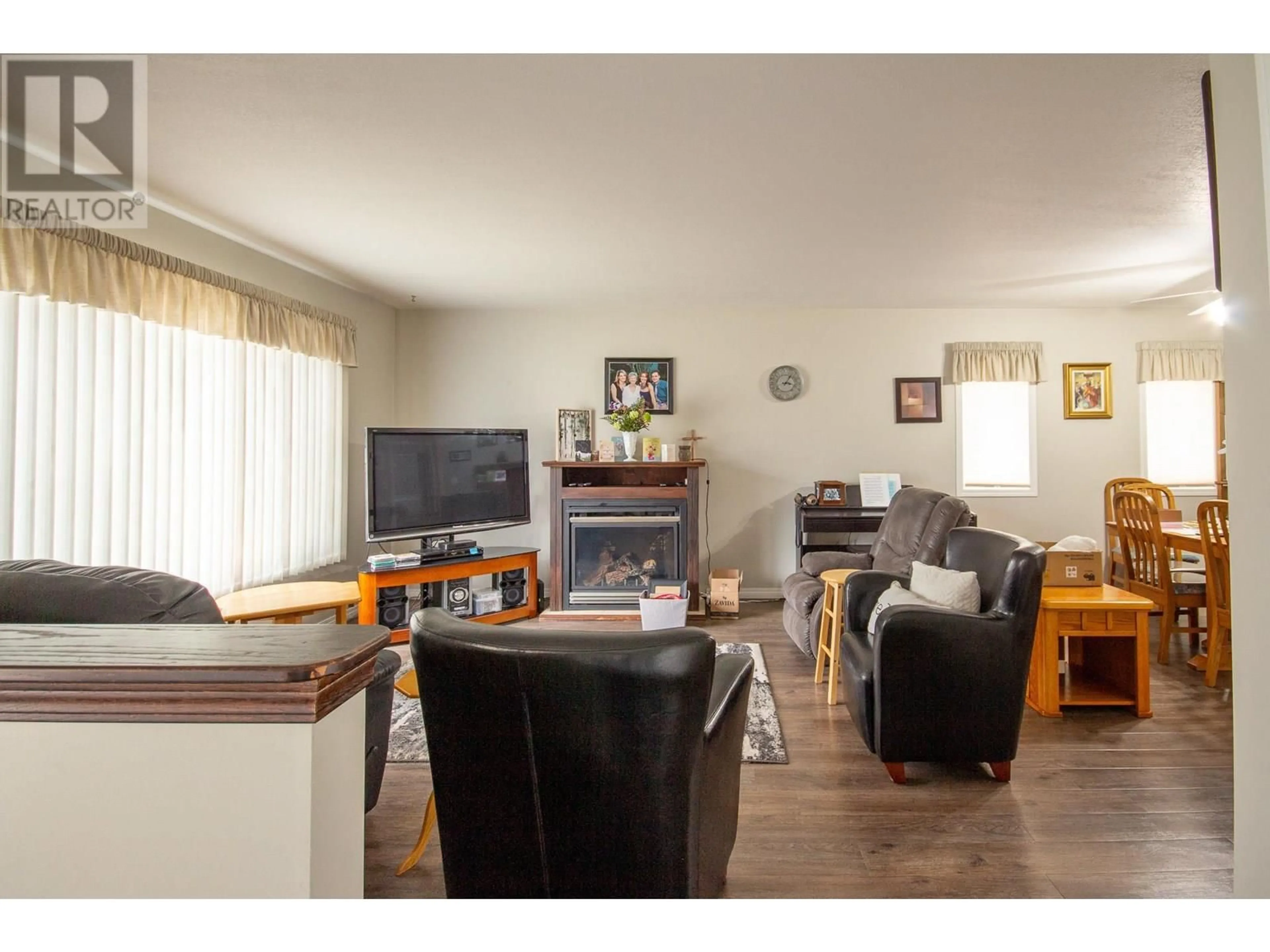 Living room with furniture, wood/laminate floor for 102 - 1708 108 AVENUE, Dawson Creek British Columbia V1G2T7