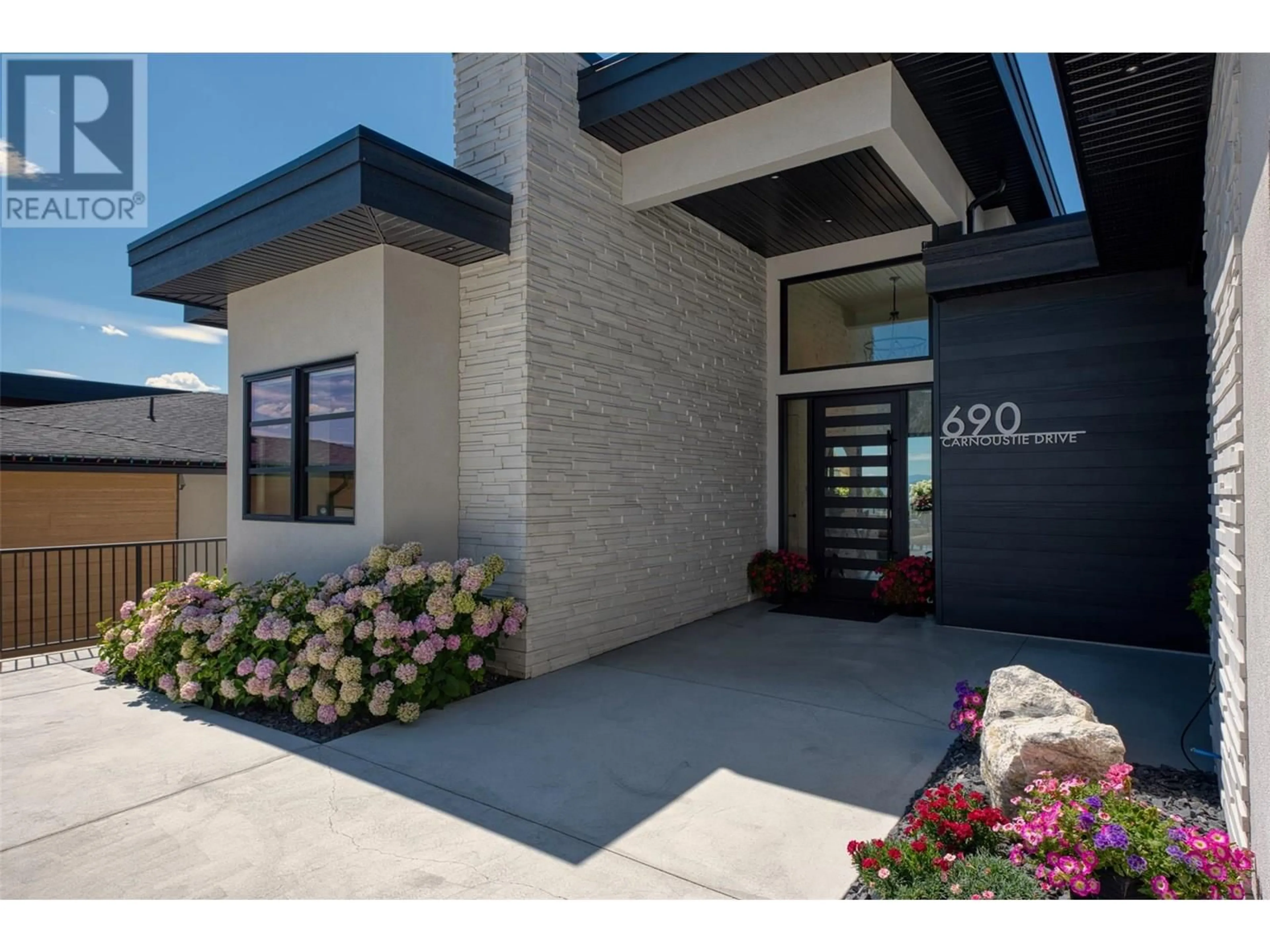 Home with brick exterior material, street for 690 CARNOUSTIE DRIVE, Kelowna British Columbia V1P1V2