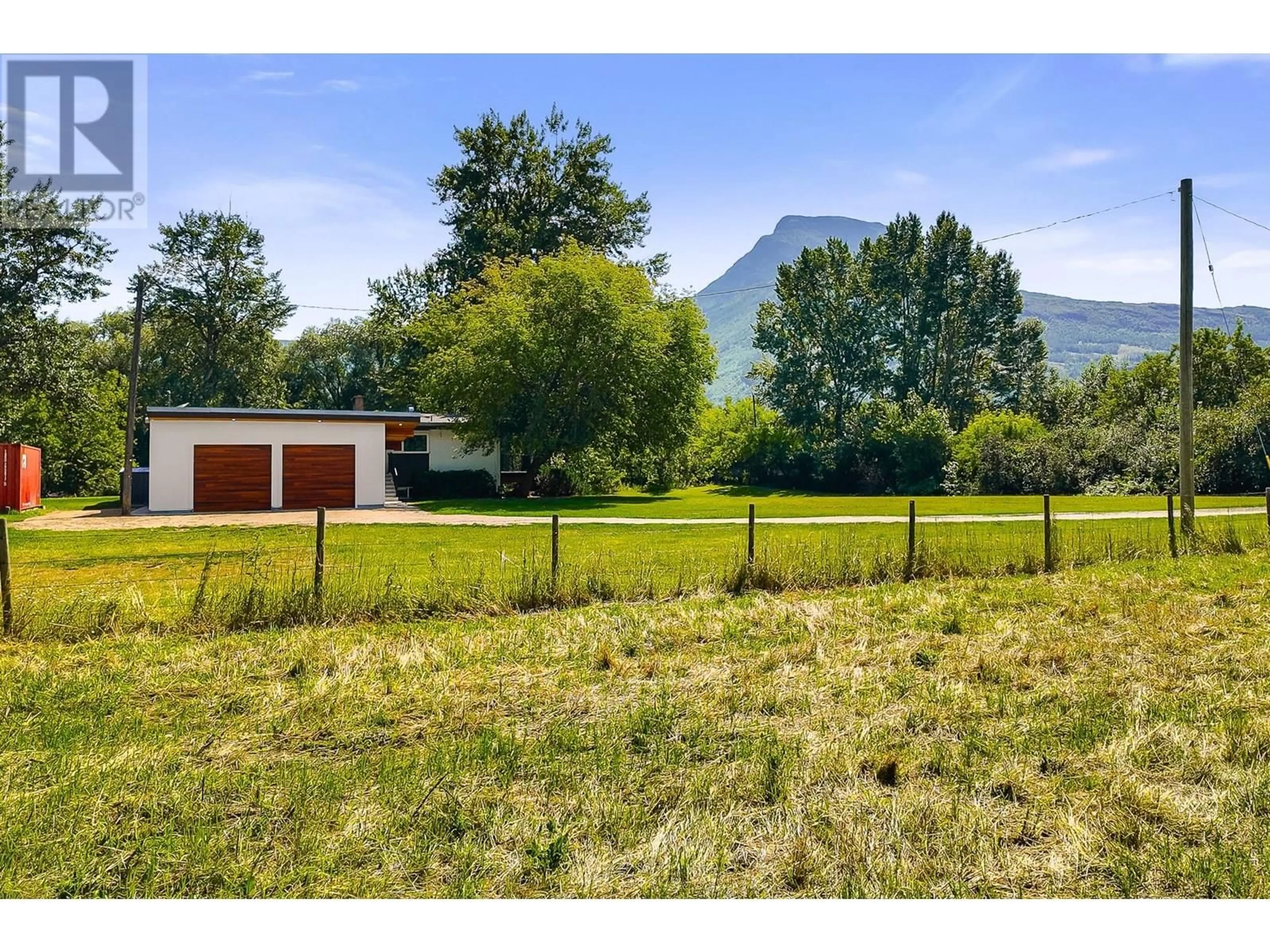 A pic from outside/outdoor area/front of a property/back of a property/a pic from drone, mountain view for 7161 50 AVENUE SOUTHWEST, Salmon Arm British Columbia V1E3C4