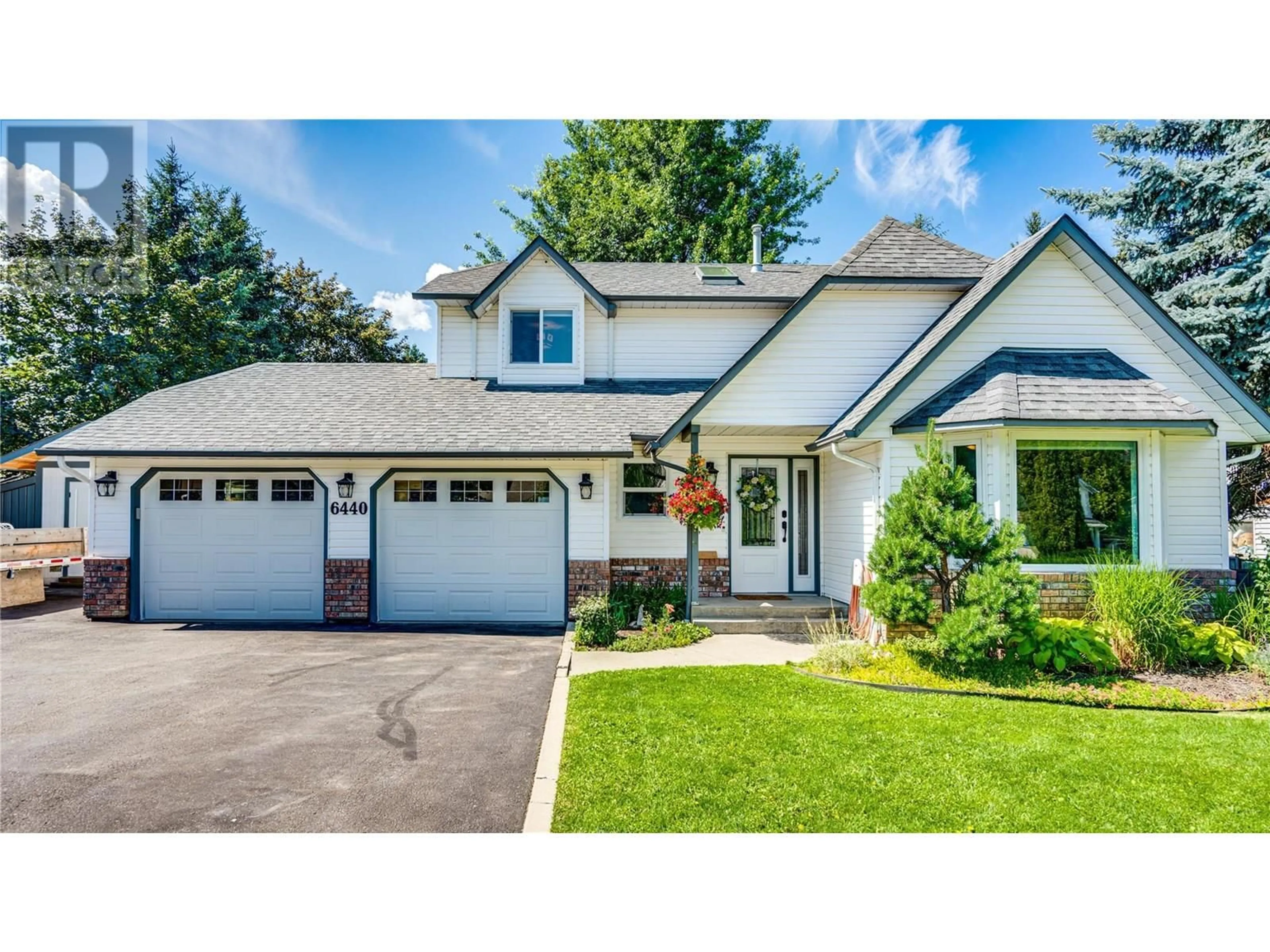Home with vinyl exterior material, street for 6440 WOODLAND DRIVE, Coldstream British Columbia V1B3G7