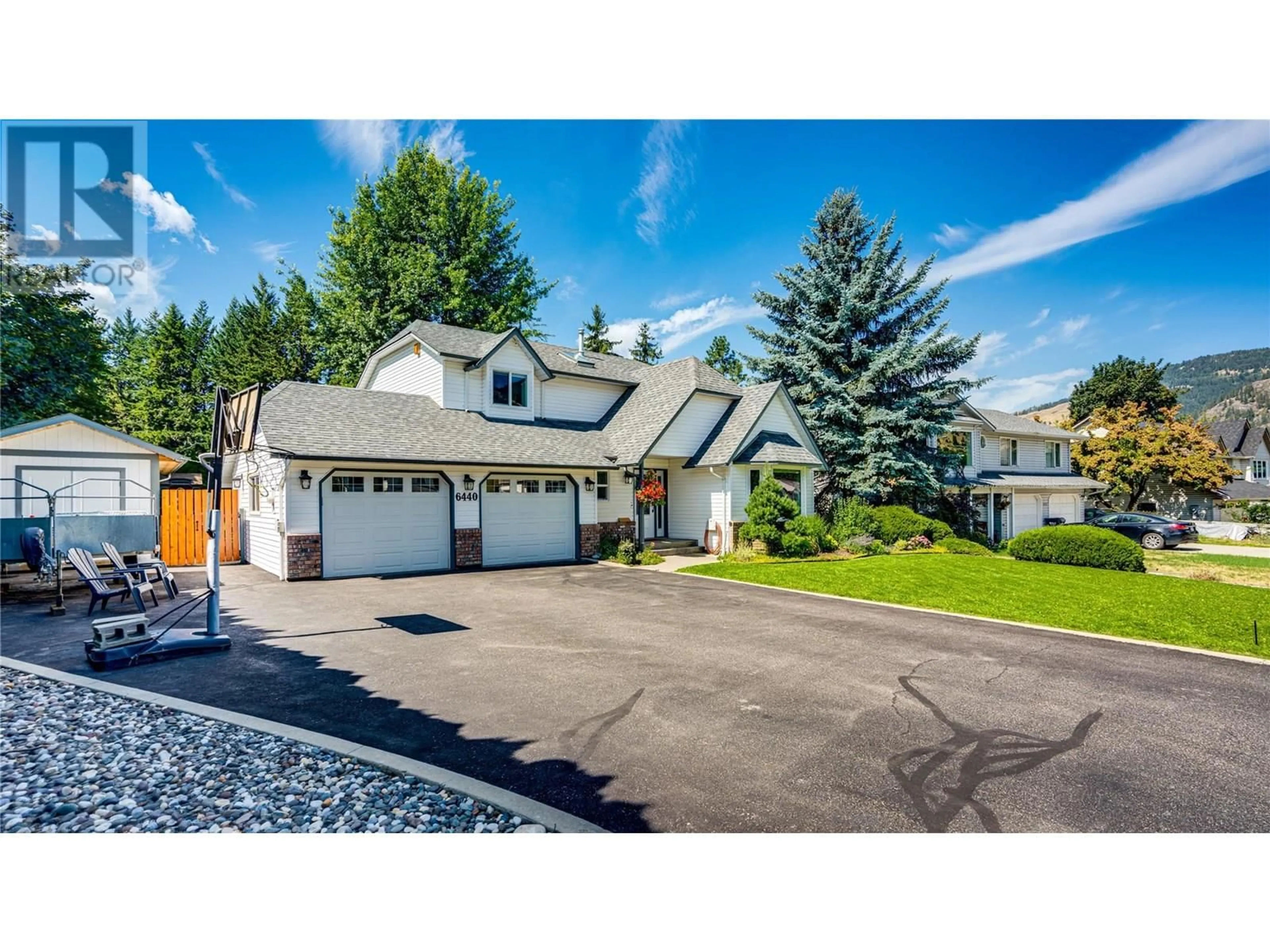 Home with vinyl exterior material, street for 6440 WOODLAND DRIVE, Coldstream British Columbia V1B3G7