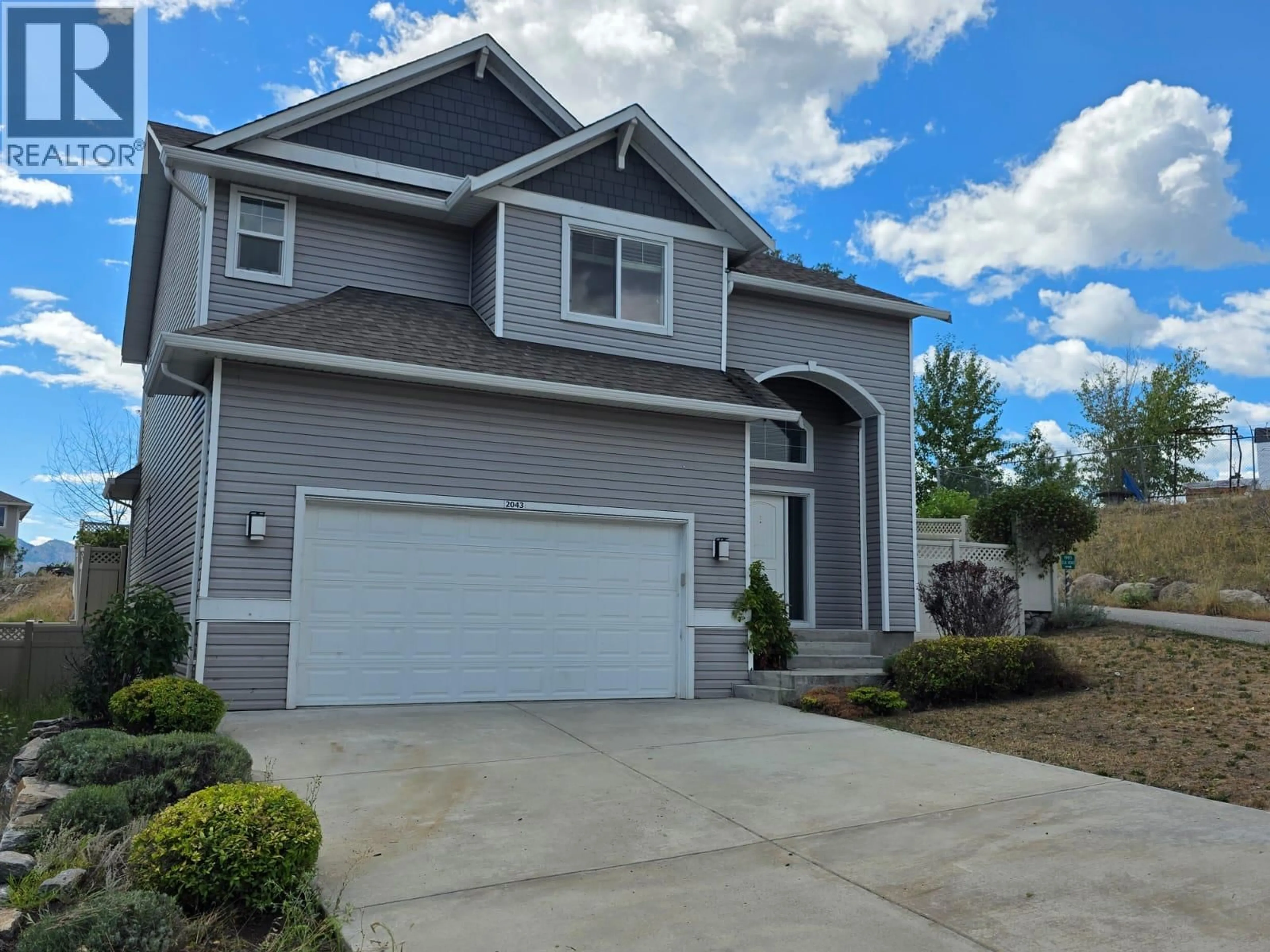 Home with vinyl exterior material, street for 2043 ELKRIDGE DRIVE, West Kelowna British Columbia V4T3K1