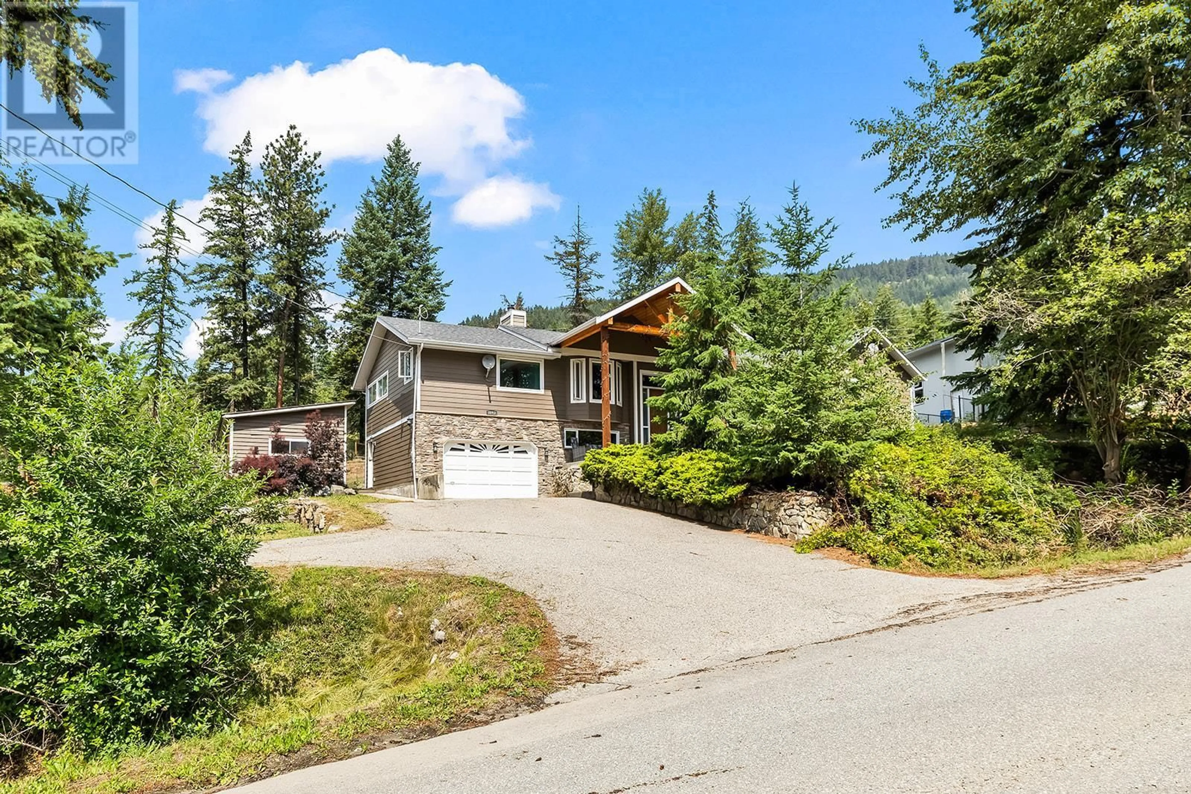 A pic from outside/outdoor area/front of a property/back of a property/a pic from drone, mountain view for 7992 FALCON RIDGE CRESCENT, Kelowna British Columbia V1P1J2