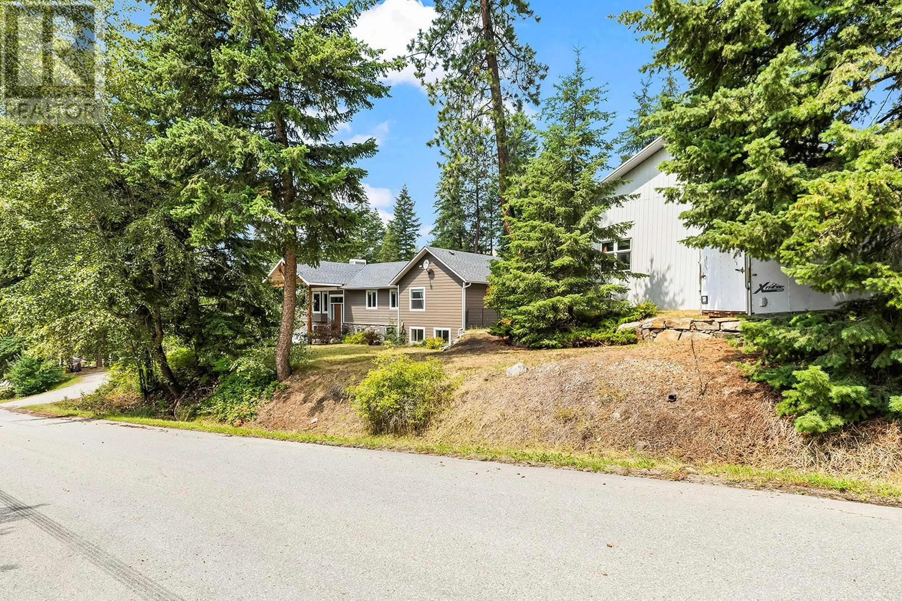 A pic from outside/outdoor area/front of a property/back of a property/a pic from drone, forest/trees view for 7992 FALCON RIDGE CRESCENT, Kelowna British Columbia V1P1J2