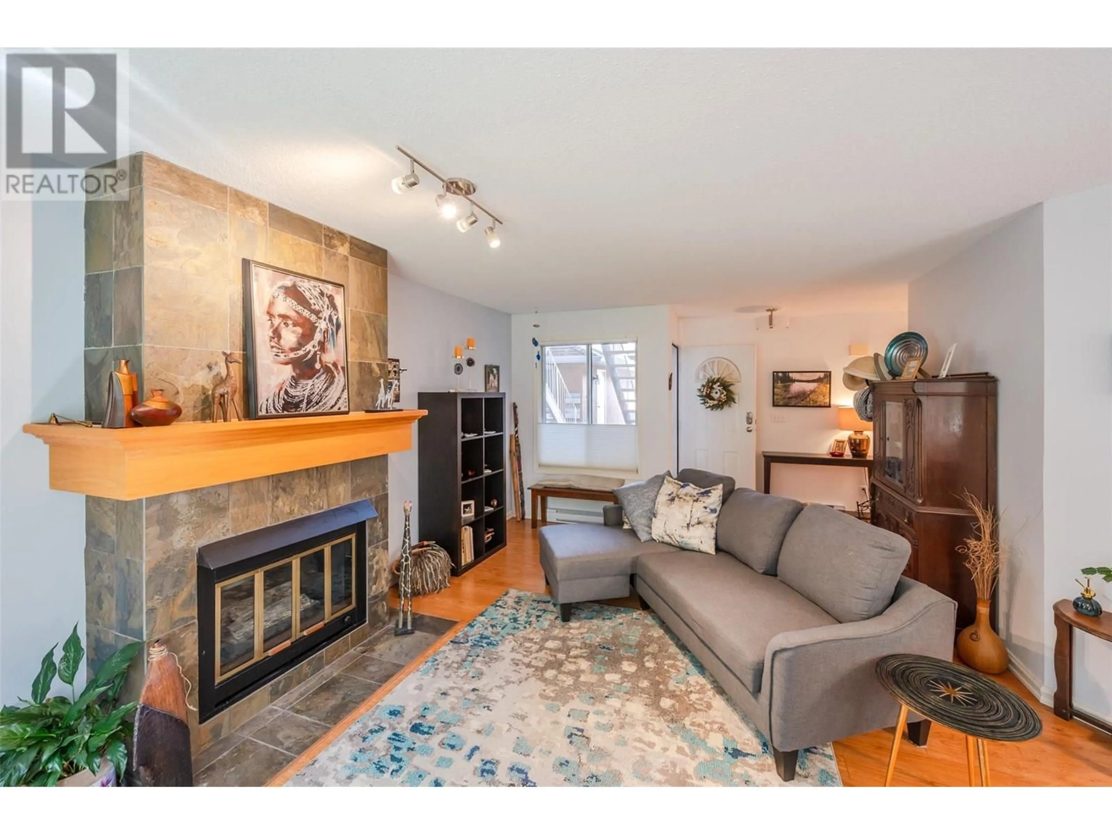 Living room with furniture, wood/laminate floor for 109 - 320 BRANDON AVENUE, Penticton British Columbia V2A3S8