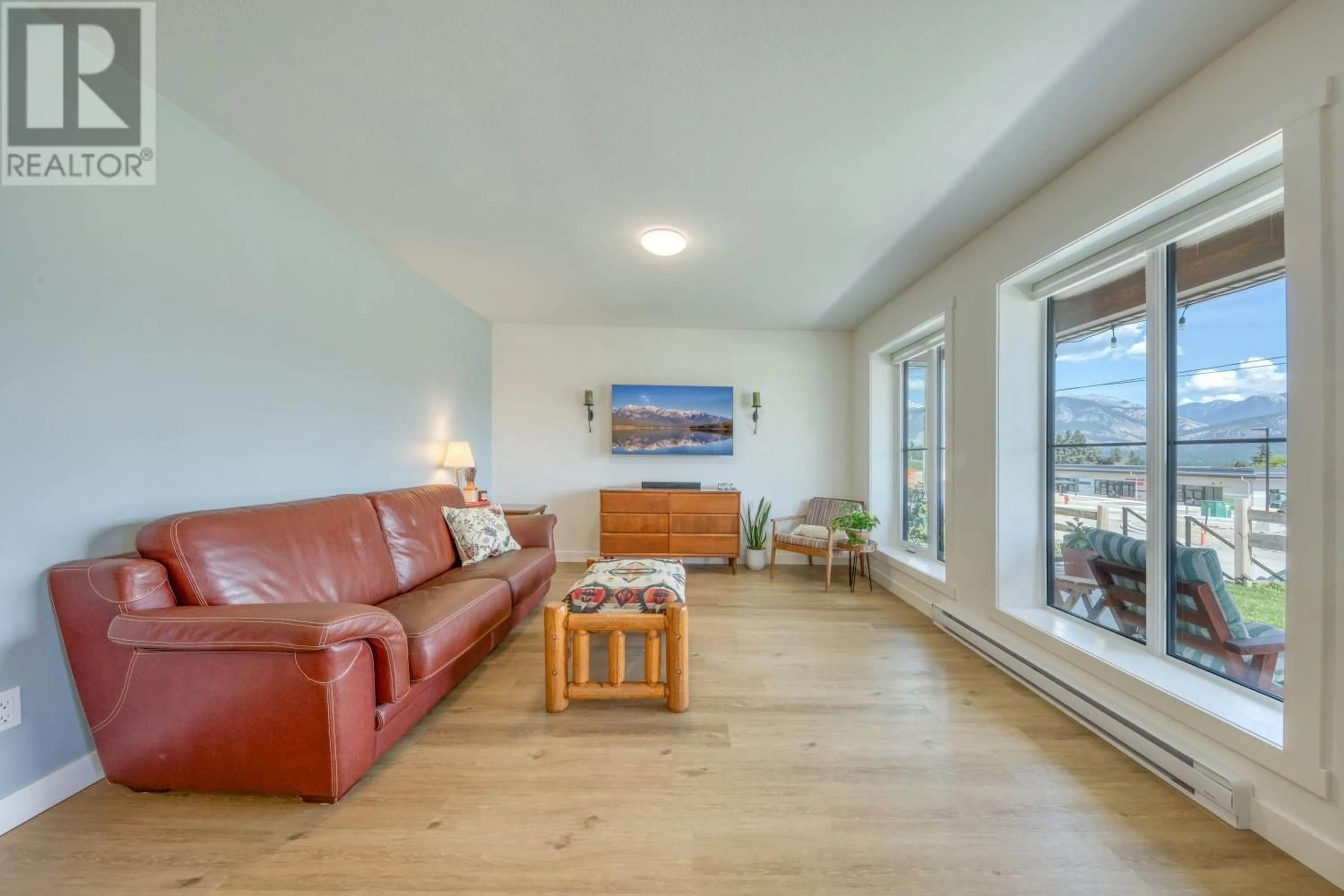 Living room with furniture, wood/laminate floor for 24 - 2101 PINE TREE WAY, Invermere British Columbia V0A1K4