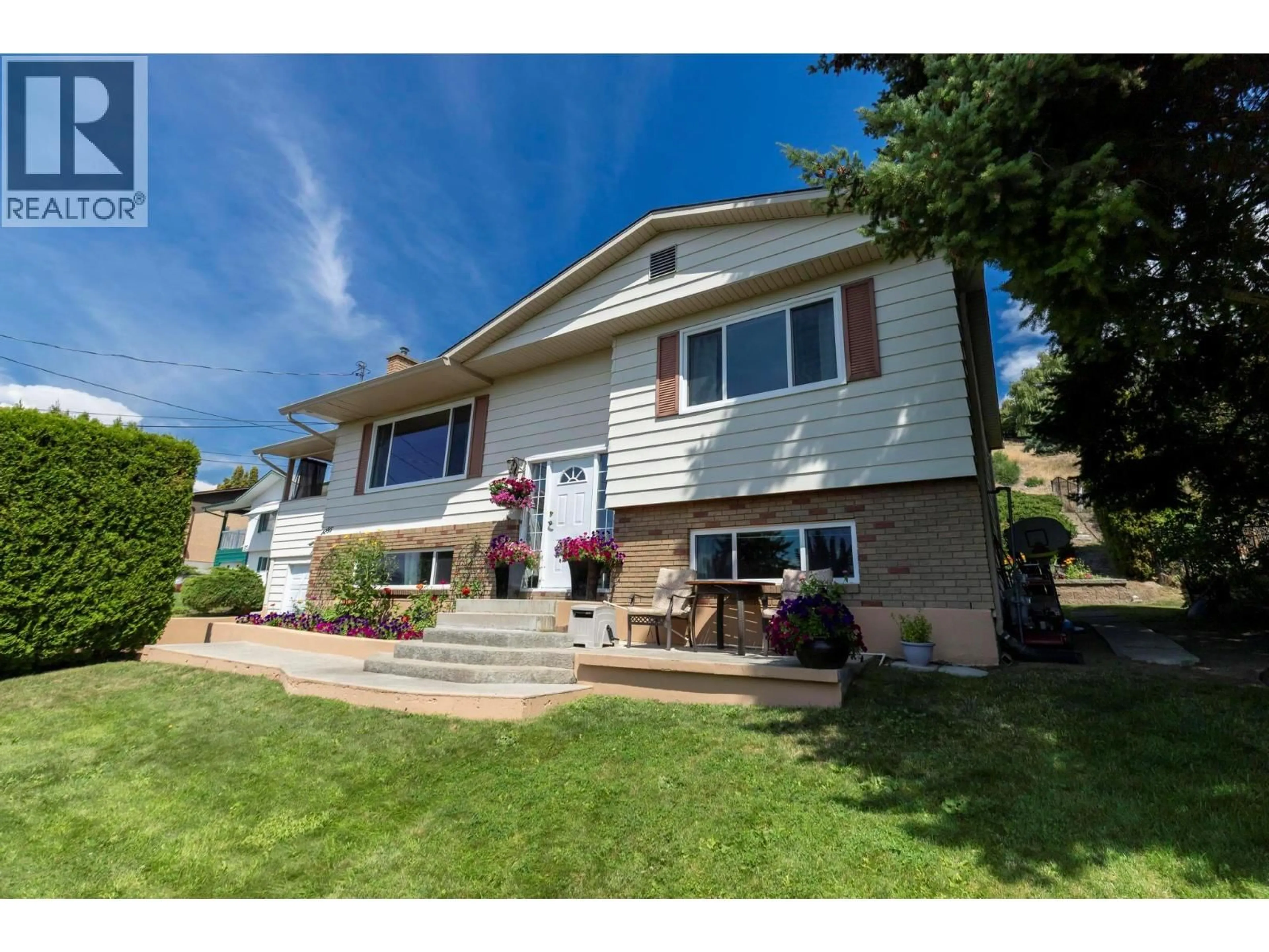 Home with vinyl exterior material, street for 1285 BEGLEY ROAD, Kelowna British Columbia V1P1K8