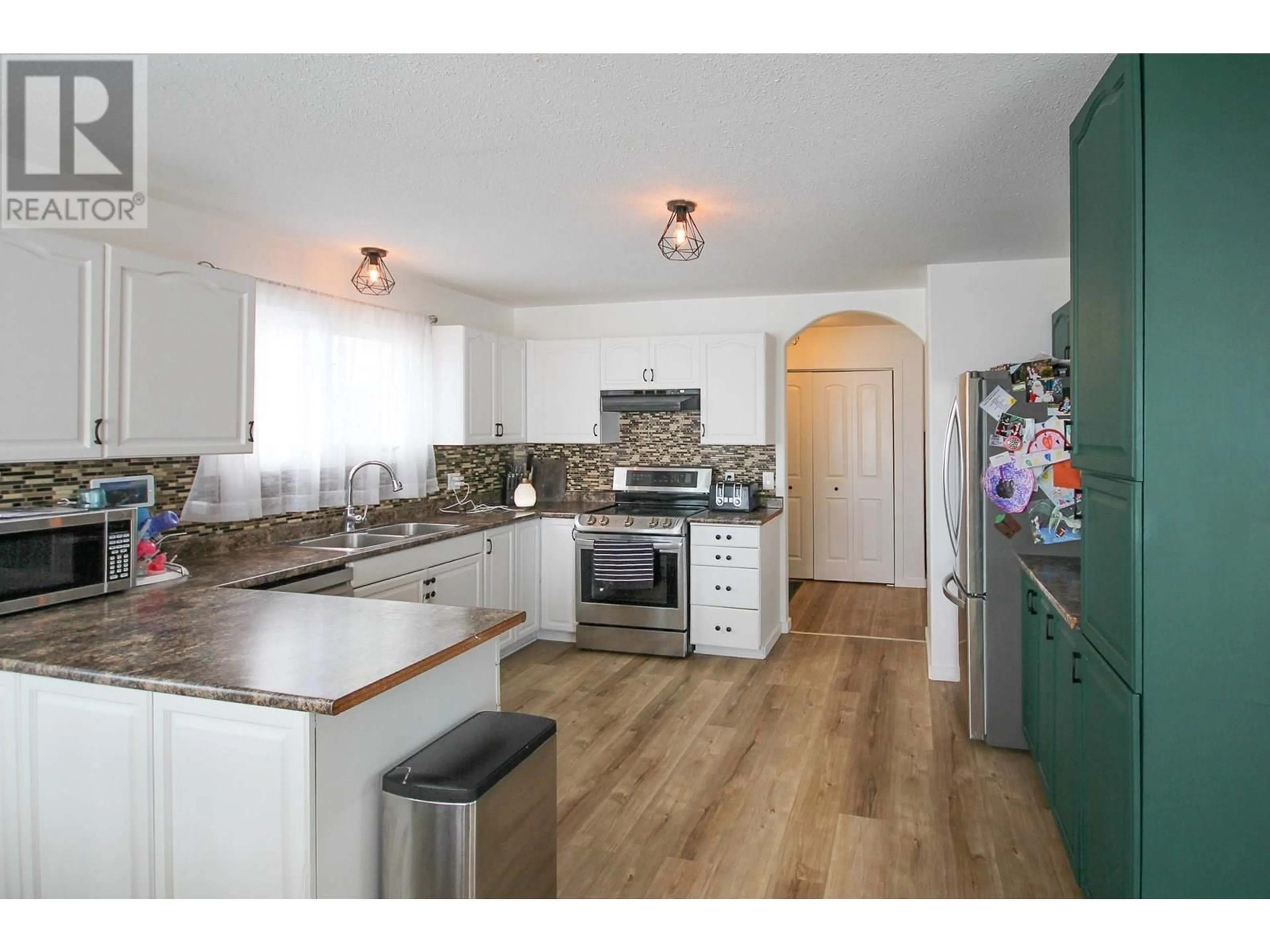 Open concept kitchen, wood/laminate floor for 8713 20A STREET, Dawson Creek British Columbia V1G4W3