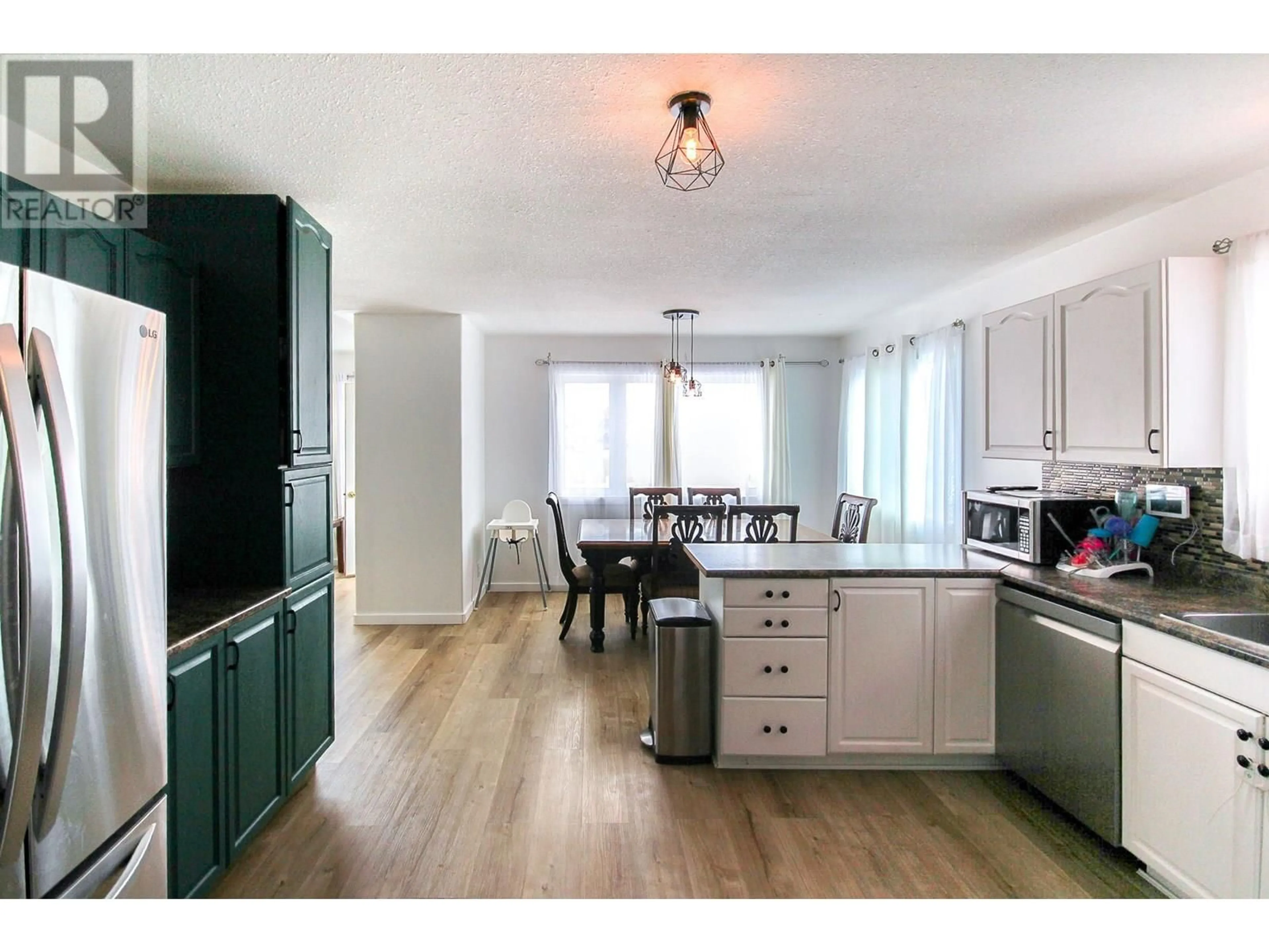 Open concept kitchen, wood/laminate floor for 8713 20A STREET, Dawson Creek British Columbia V1G4W3