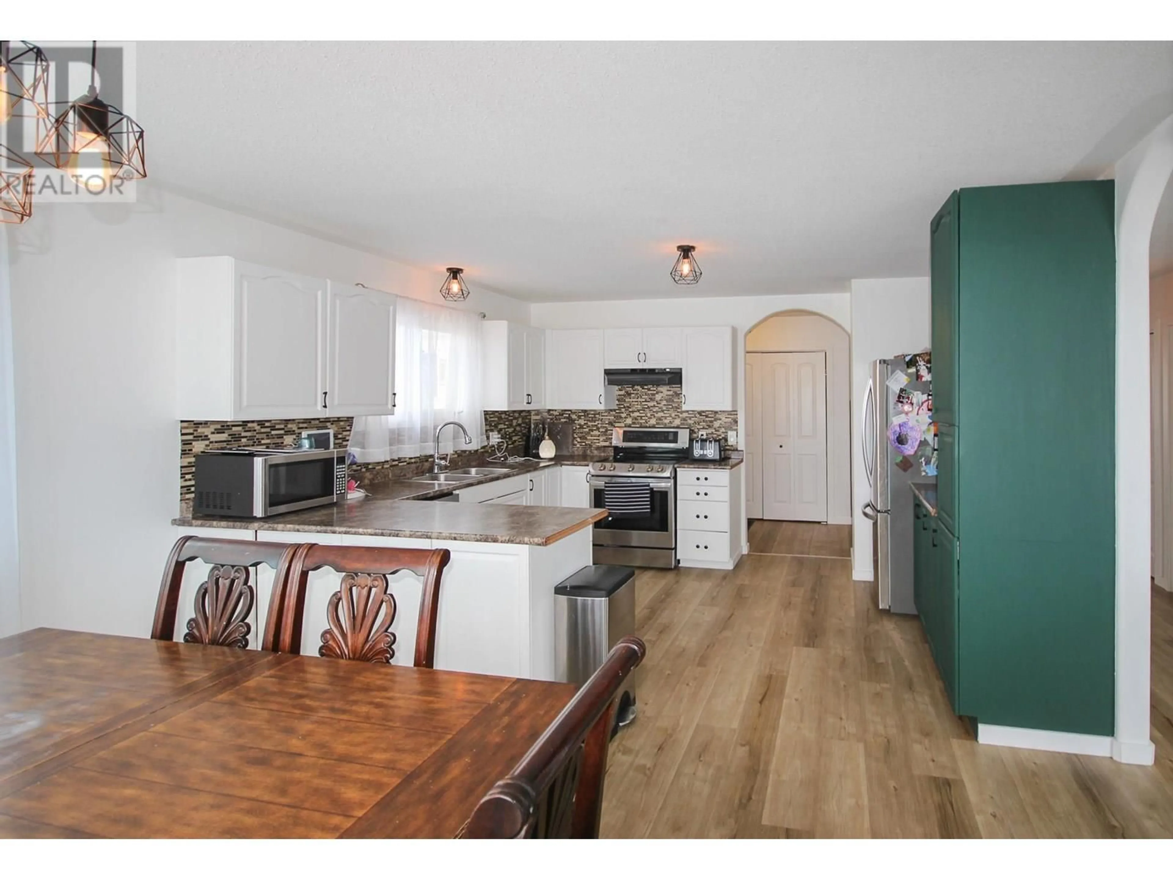 Open concept kitchen, wood/laminate floor for 8713 20A STREET, Dawson Creek British Columbia V1G4W3