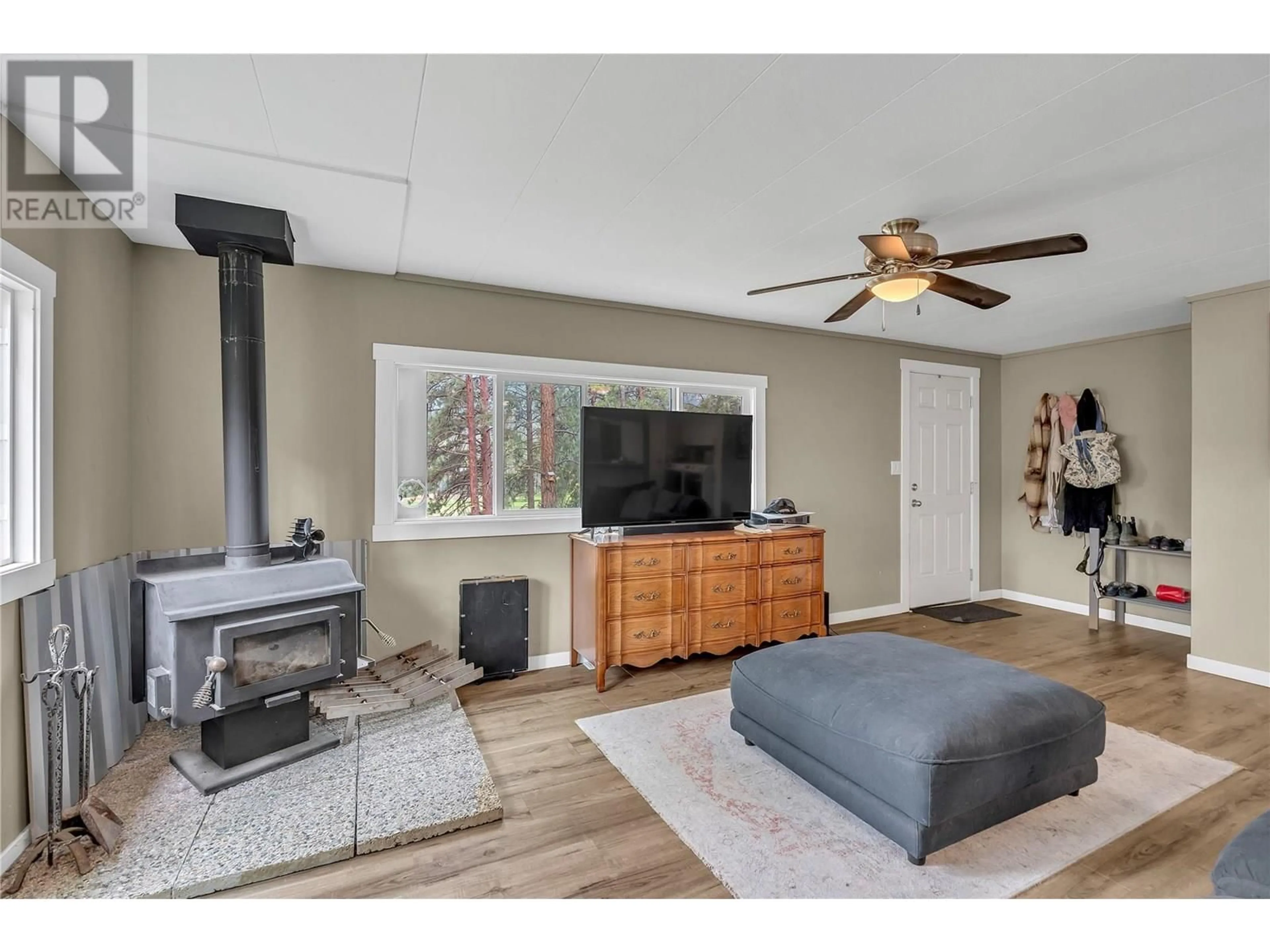 Living room with furniture, wood/laminate floor for 501 FISH LAKE ROAD, Summerland British Columbia V0H1Z8