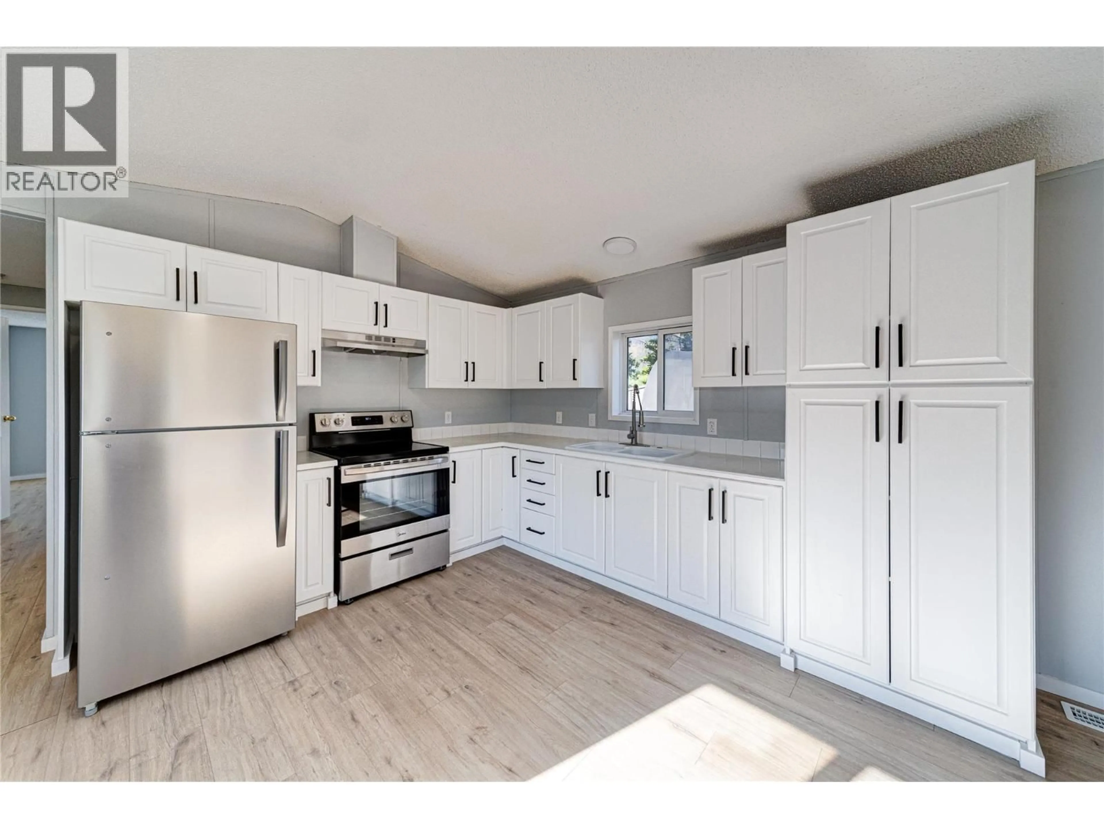 Open concept kitchen, wood/laminate floor for E7-7555 HIGHWAY 43 OTHER, Sparwood British Columbia V0B2G1
