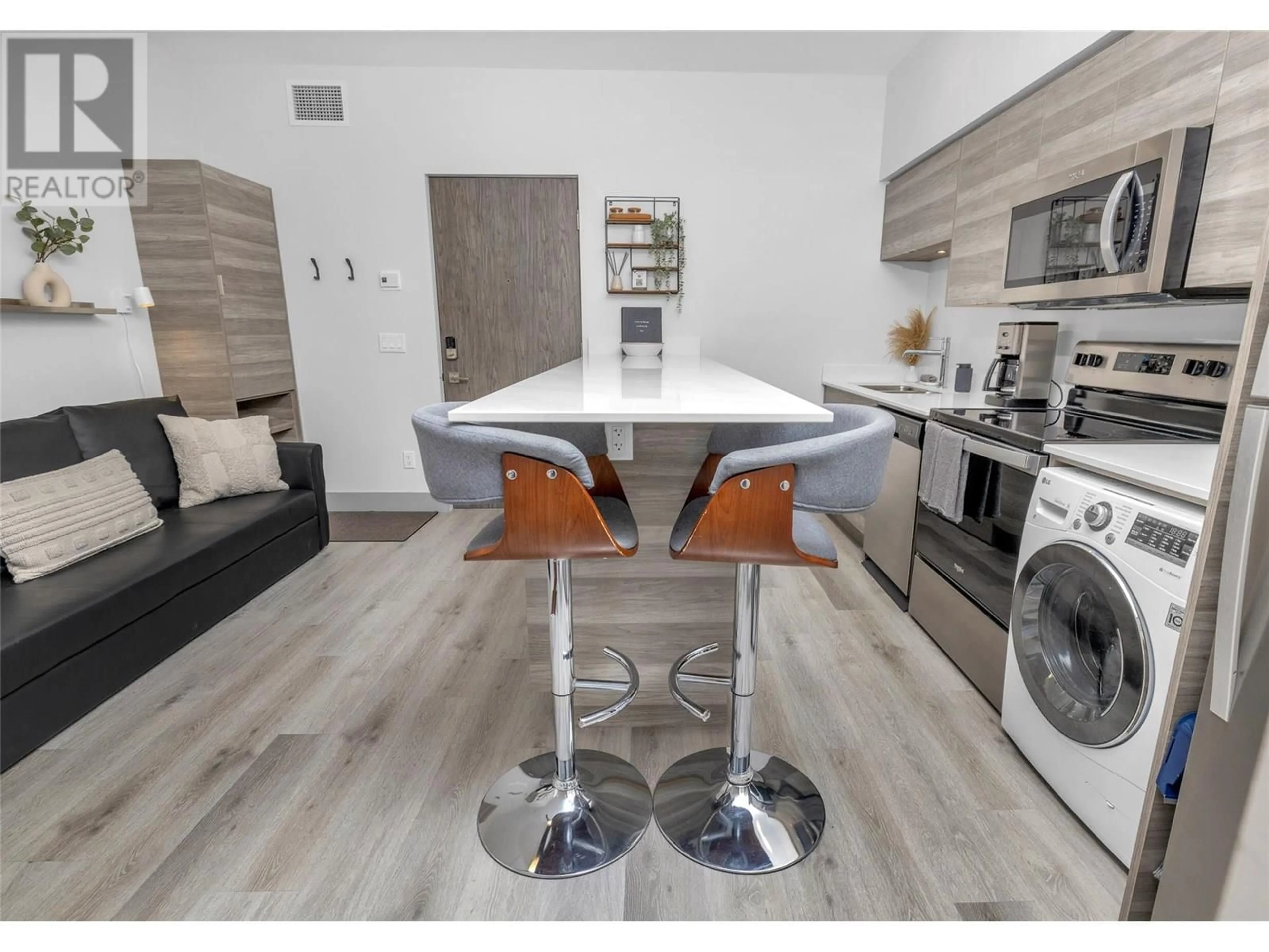 Open concept kitchen, wood/laminate floor for 211 - 2555 LAKESHORE ROAD, Vernon British Columbia V1H0A4