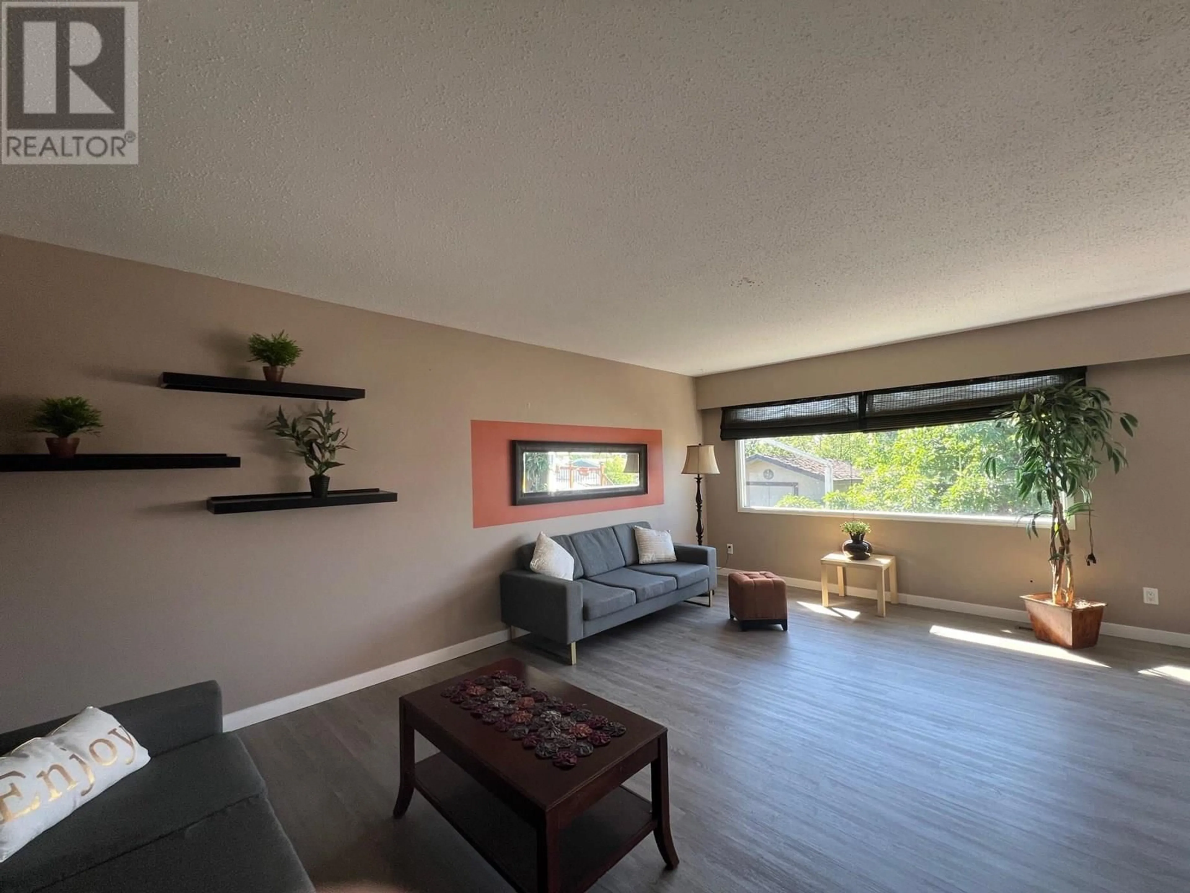 Living room with furniture, wood/laminate floor for 1049 92 AVENUE, Dawson Creek British Columbia V1G1C2