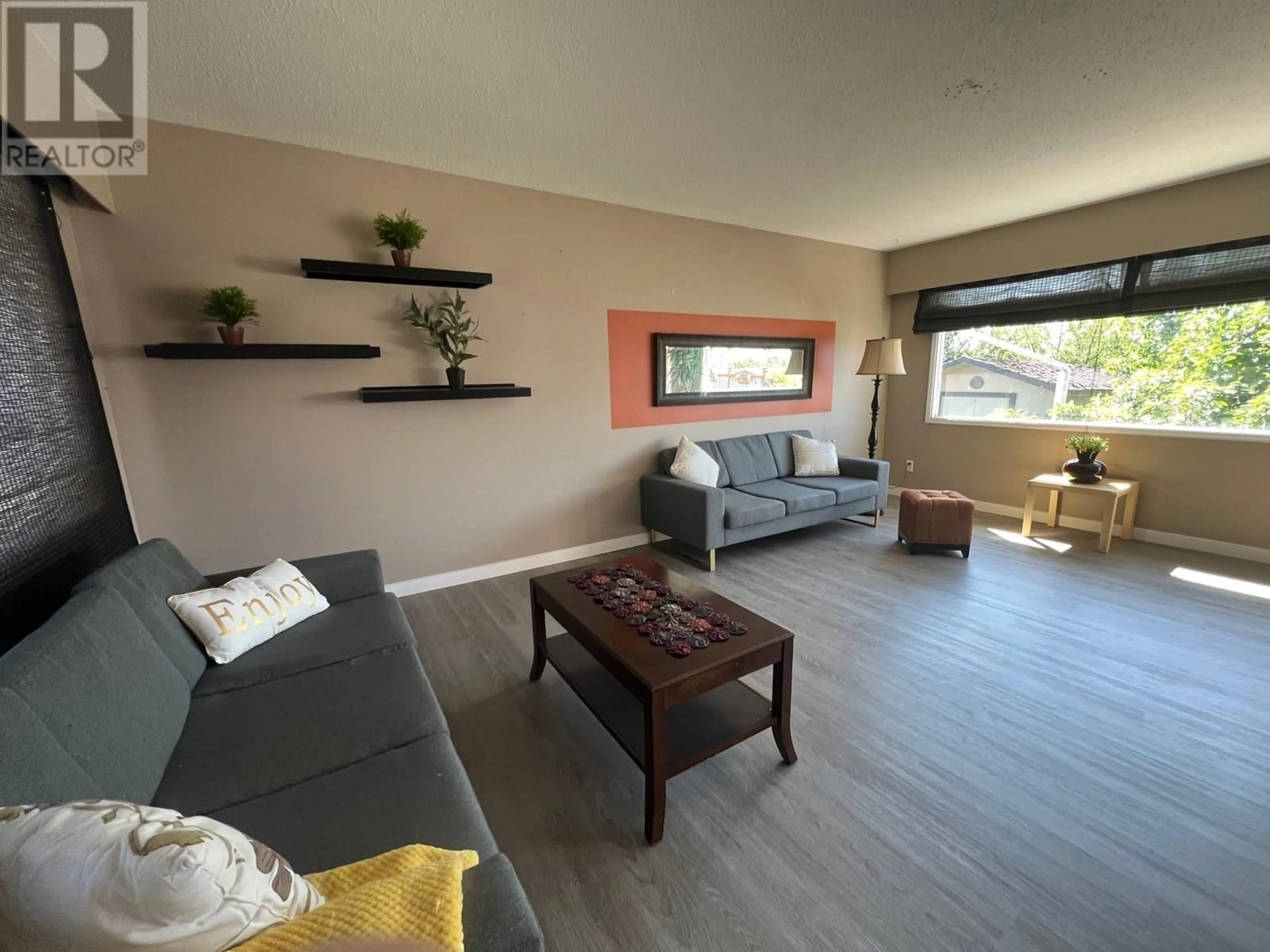 Living room with furniture, wood/laminate floor for 1049 92 AVENUE, Dawson Creek British Columbia V1G1C2