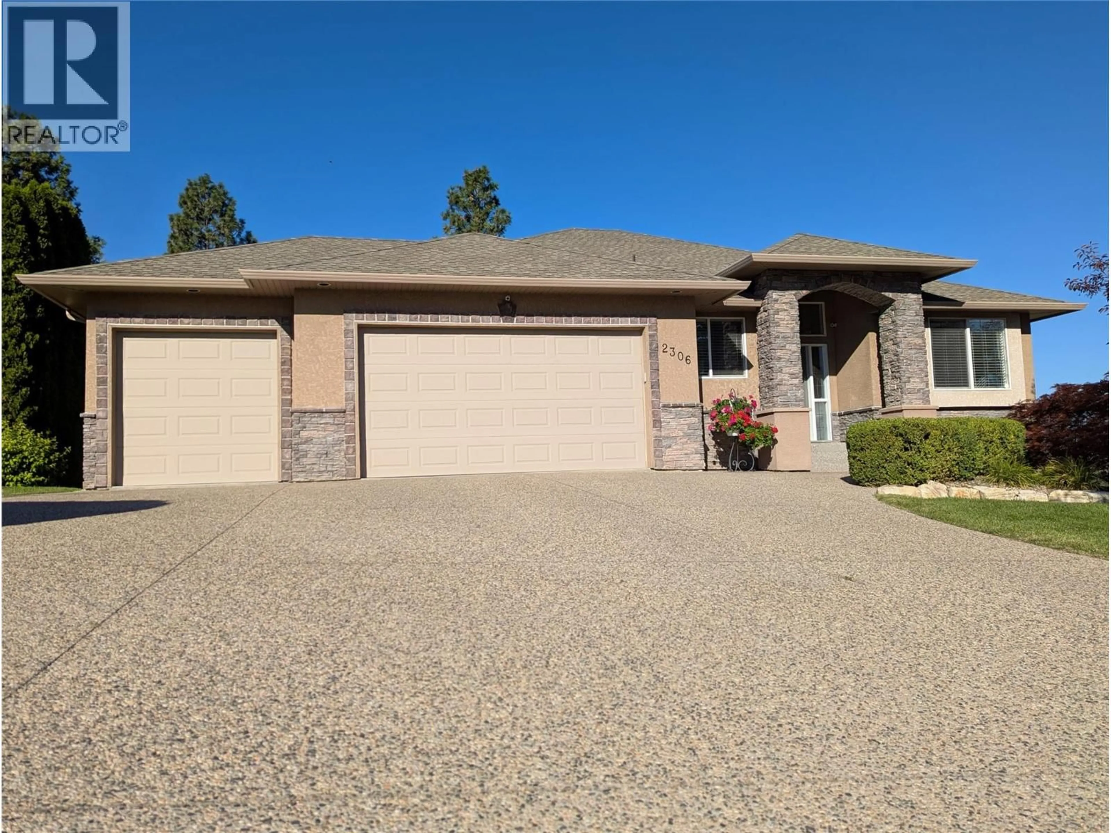 Home with brick exterior material, street for 2306 QUAIL RUN DRIVE, Kelowna British Columbia V1V2S3
