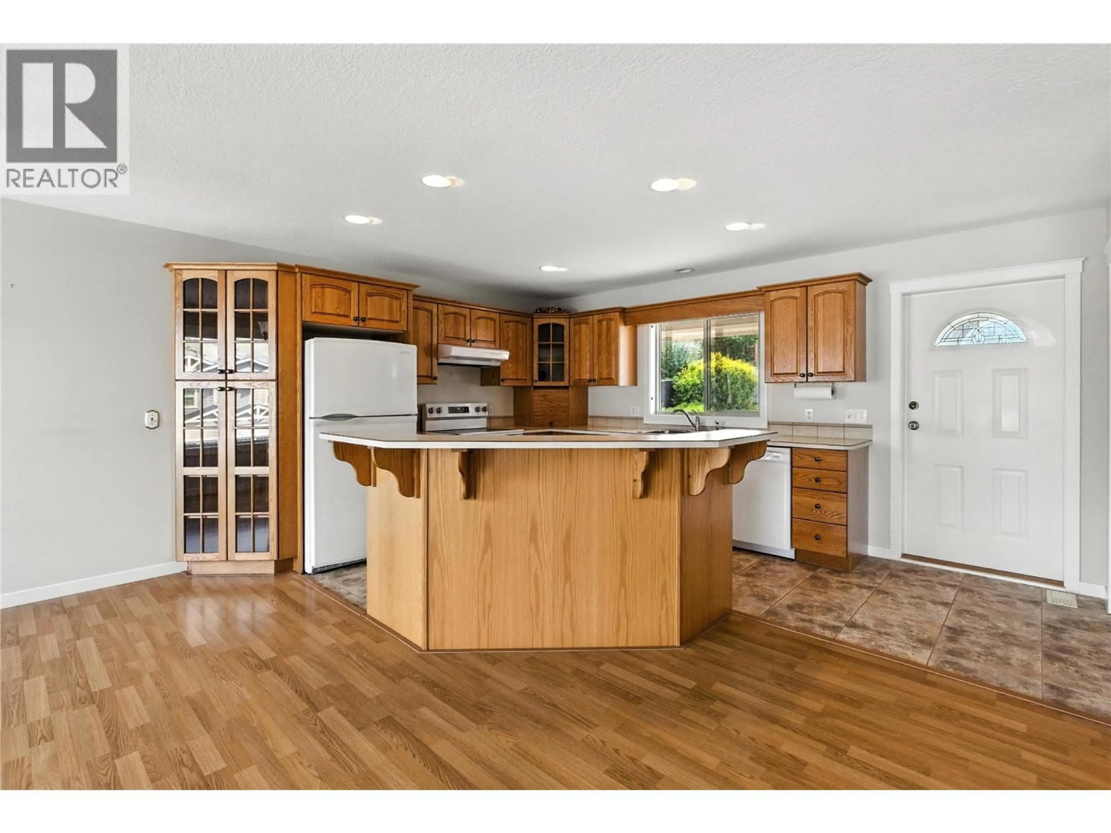 Open concept kitchen, wood/laminate floor for 4504 BELLEVUE DRIVE, Vernon British Columbia V1T9L5