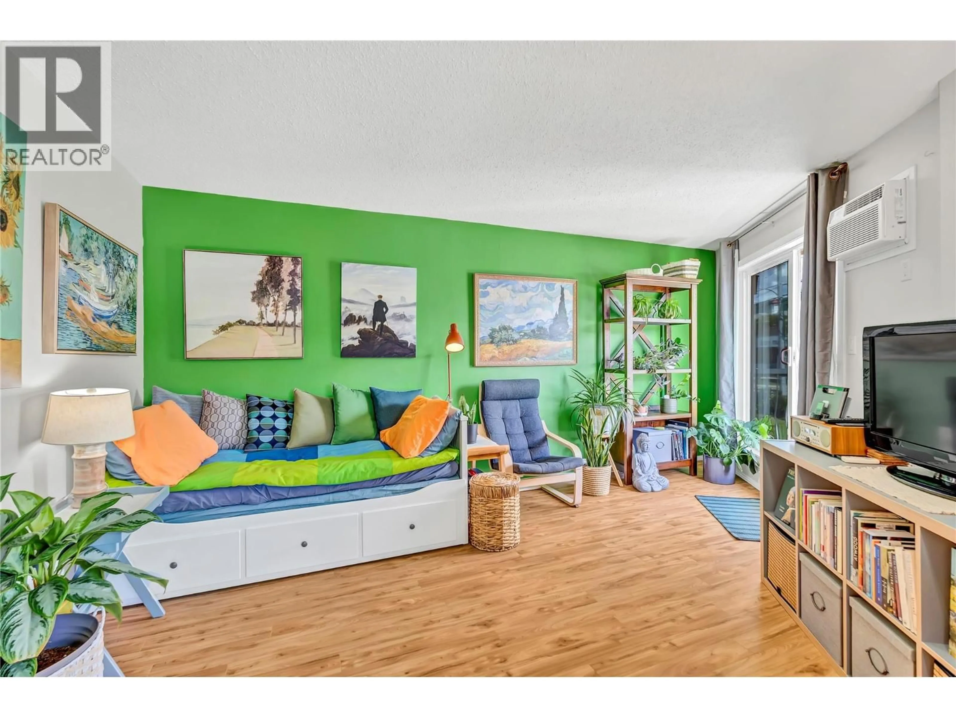 Living room with furniture, wood/laminate floor for 201 - 803 FAIRVIEW ROAD, Penticton British Columbia V2A5Y7