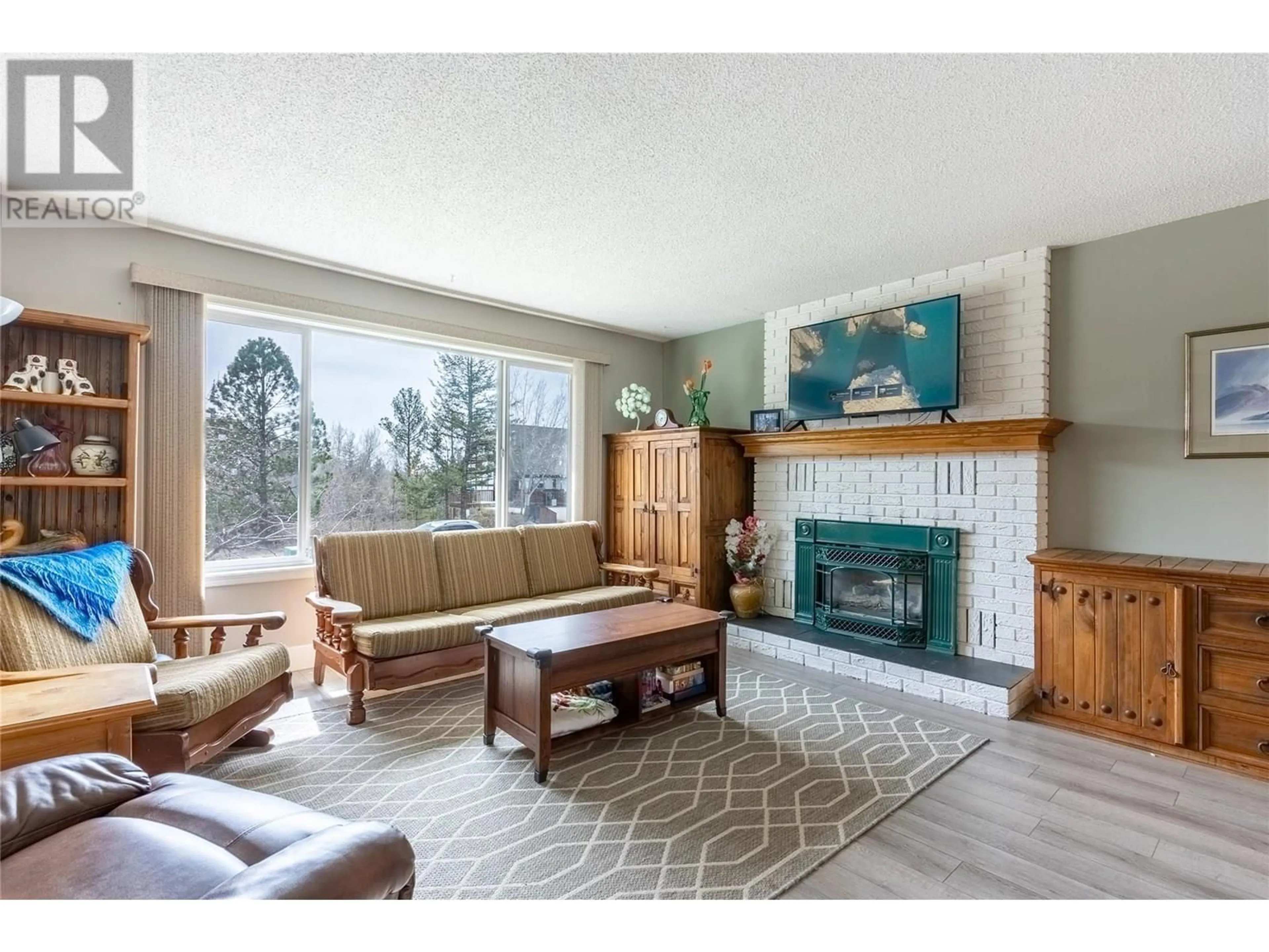 Living room with furniture, wood/laminate floor for 281 POPLAR DRIVE, Logan Lake British Columbia V0K1W0