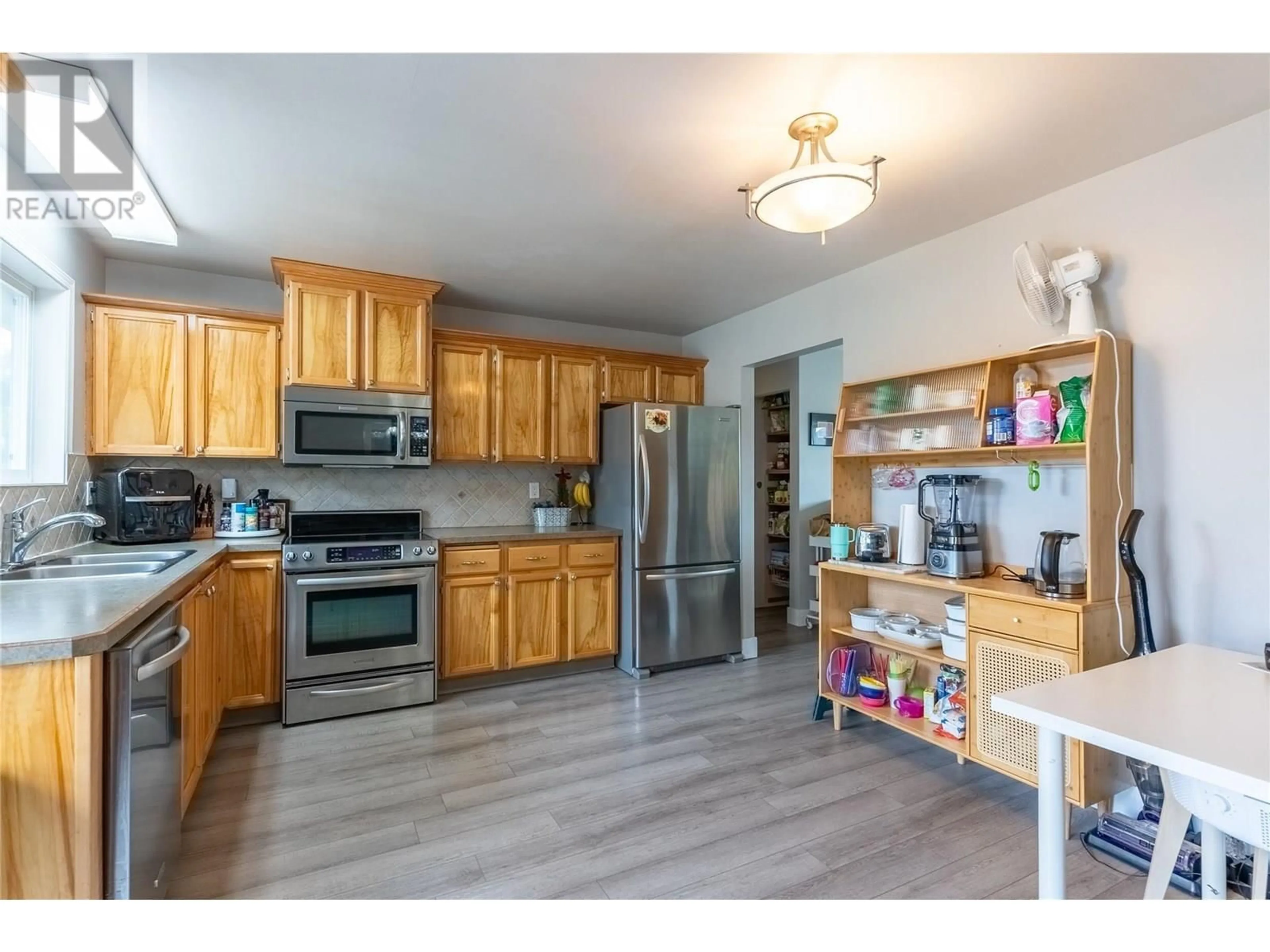 Open concept kitchen, wood/laminate floor for 281 POPLAR DRIVE, Logan Lake British Columbia V0K1W0