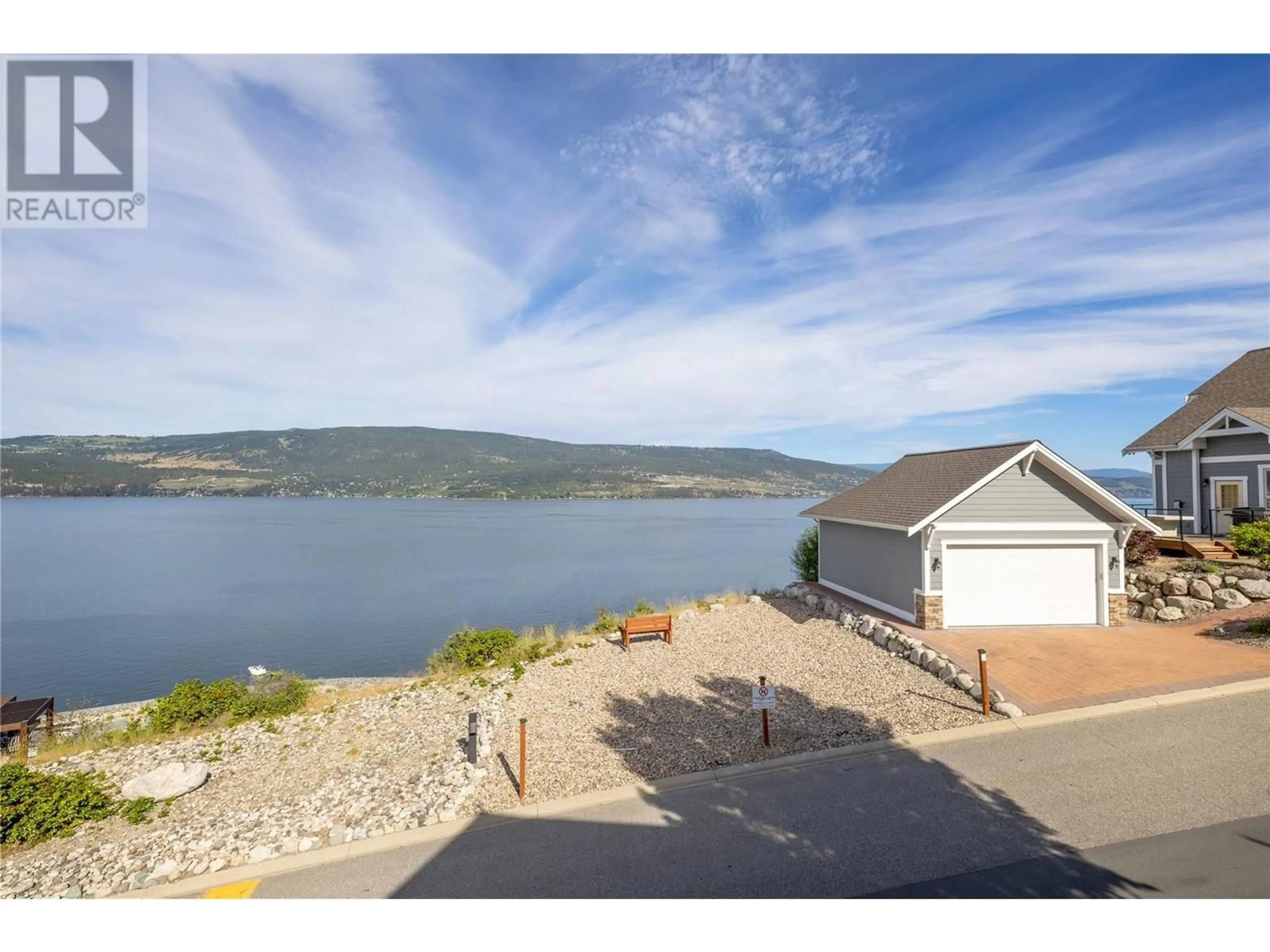 A pic from outside/outdoor area/front of a property/back of a property/a pic from drone, water/lake/river/ocean view for 47 - 6930 BARCELONA DRIVE EAST, Fintry British Columbia V1Z3R8