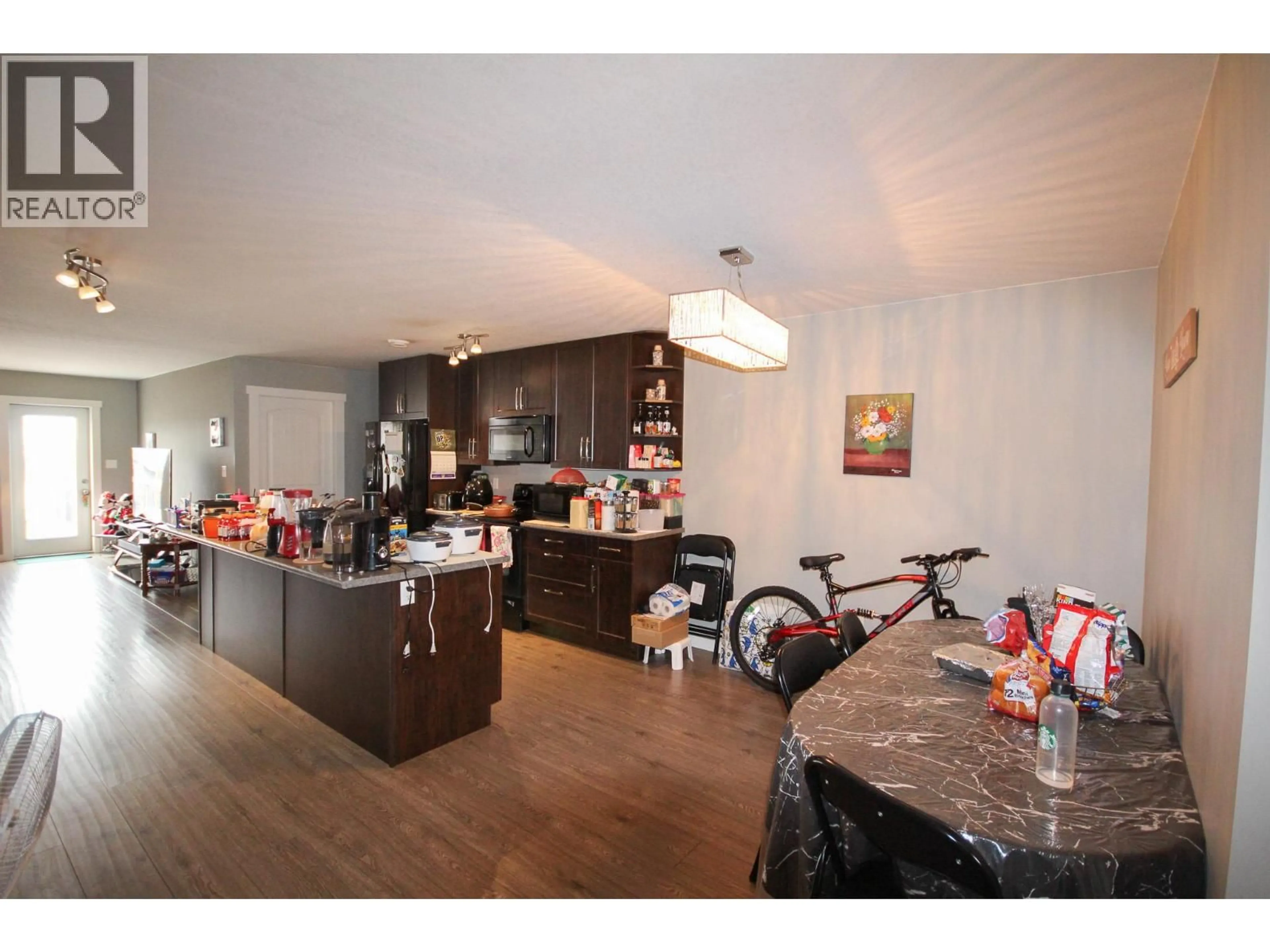 Open concept kitchen, wood/laminate floor for 8219 18 STREET, Dawson Creek British Columbia V1G0G4