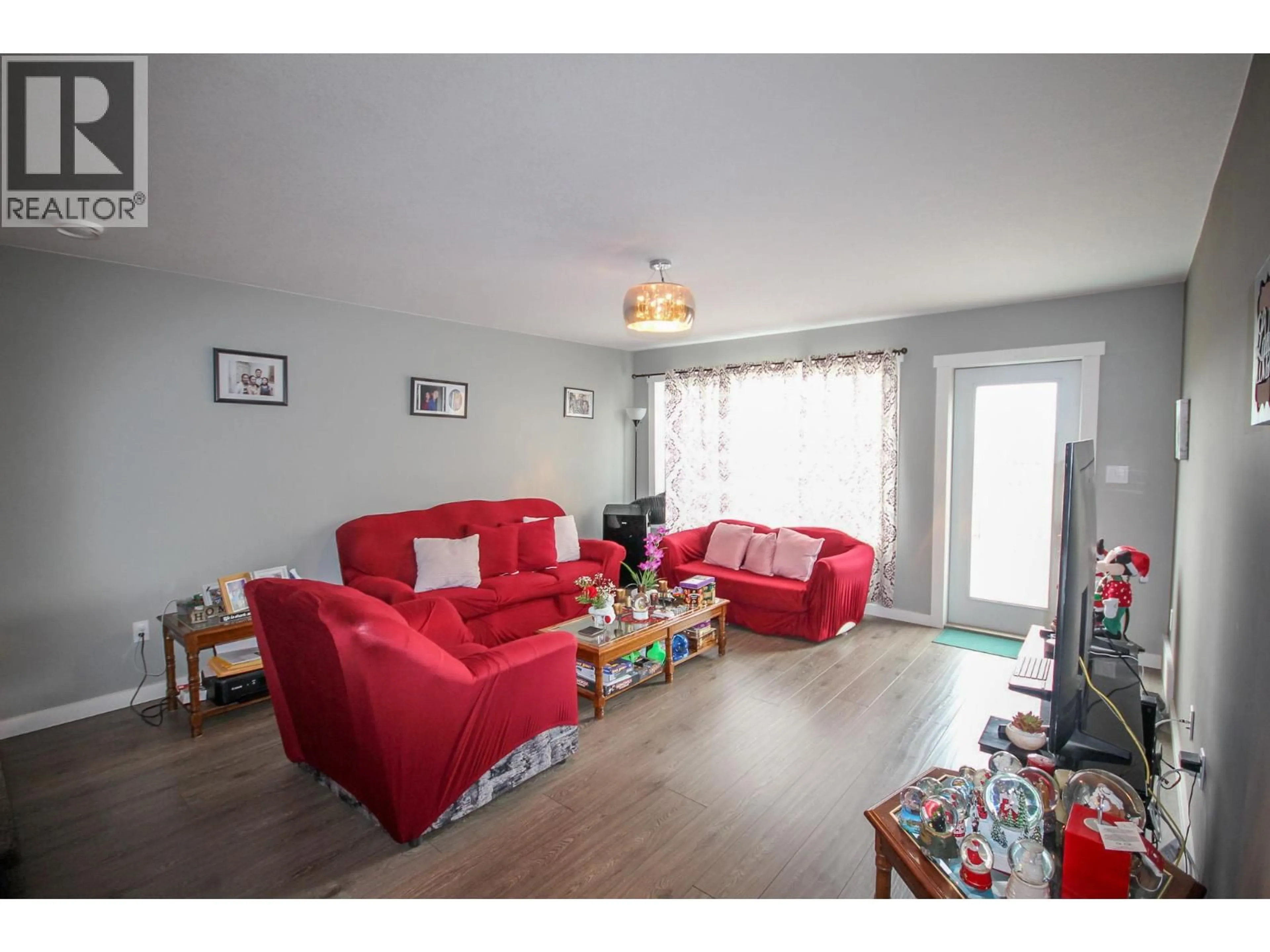 Living room with furniture, wood/laminate floor for 8219 18 STREET, Dawson Creek British Columbia V1G0G4