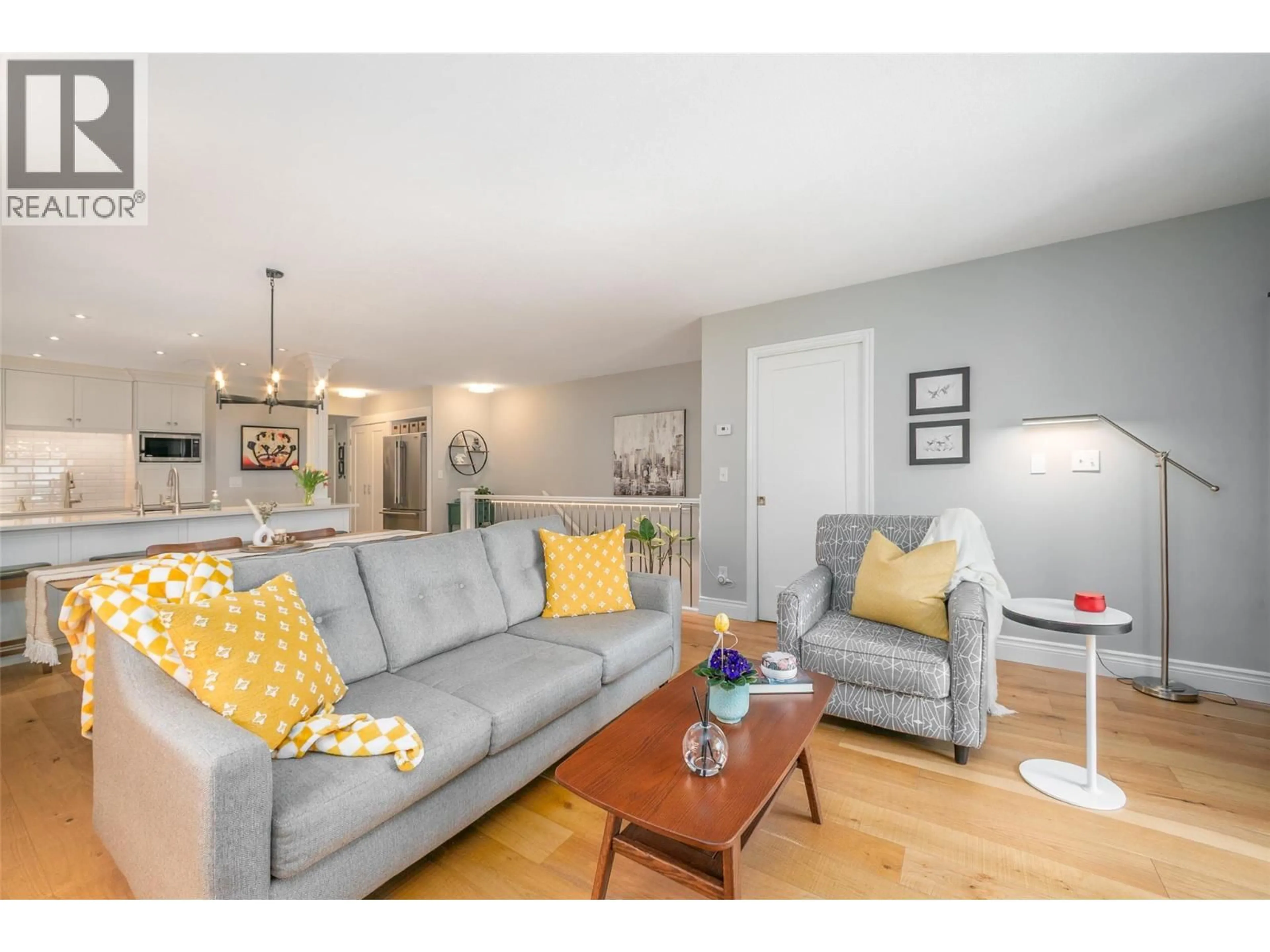 Living room with furniture, wood/laminate floor for 216 - 2350 STILLINGFLEET ROAD, Kelowna British Columbia V1W3X9