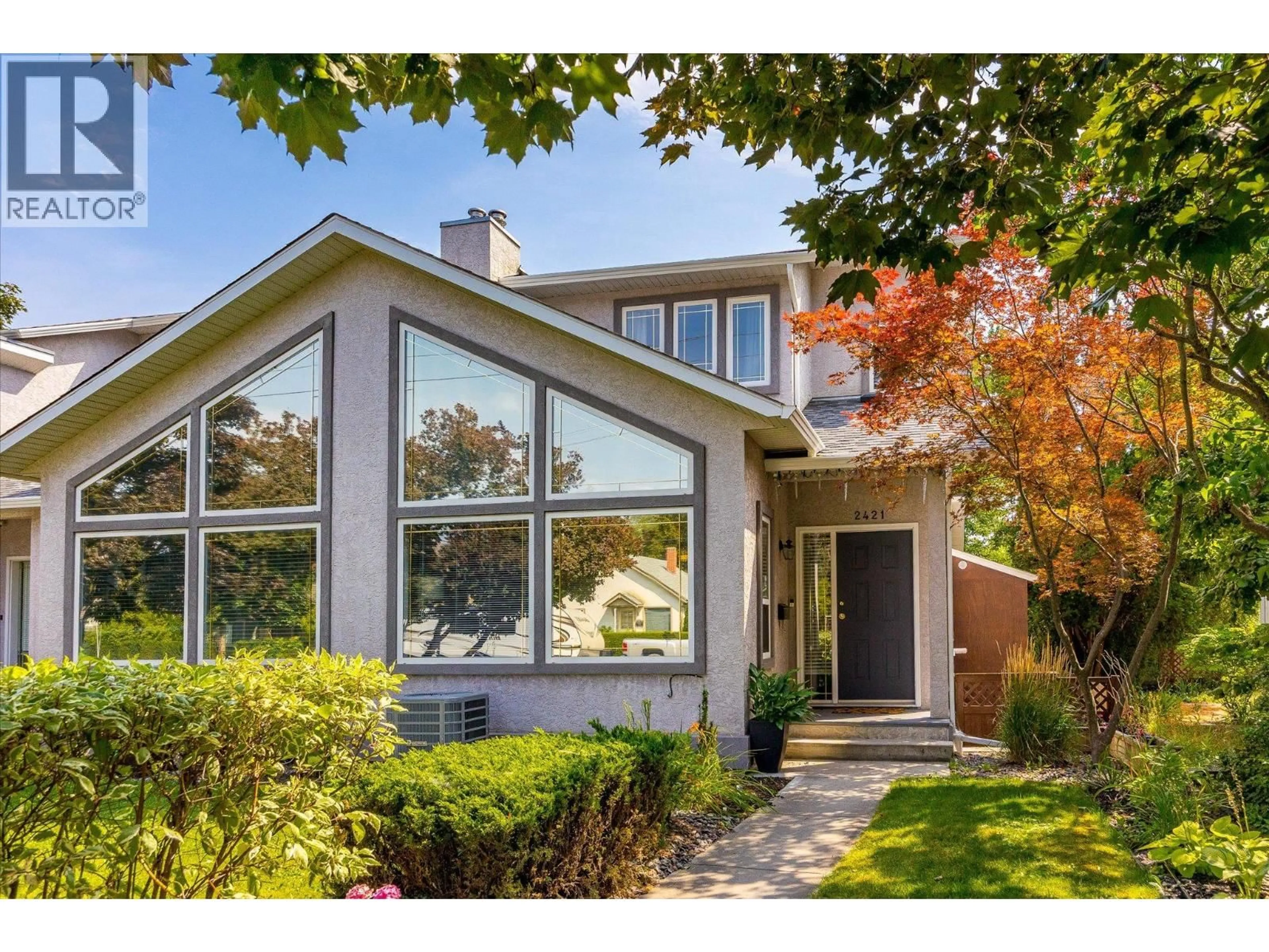 Home with vinyl exterior material, street for 2421 RICHTER STREET, Kelowna British Columbia V1Y2P5