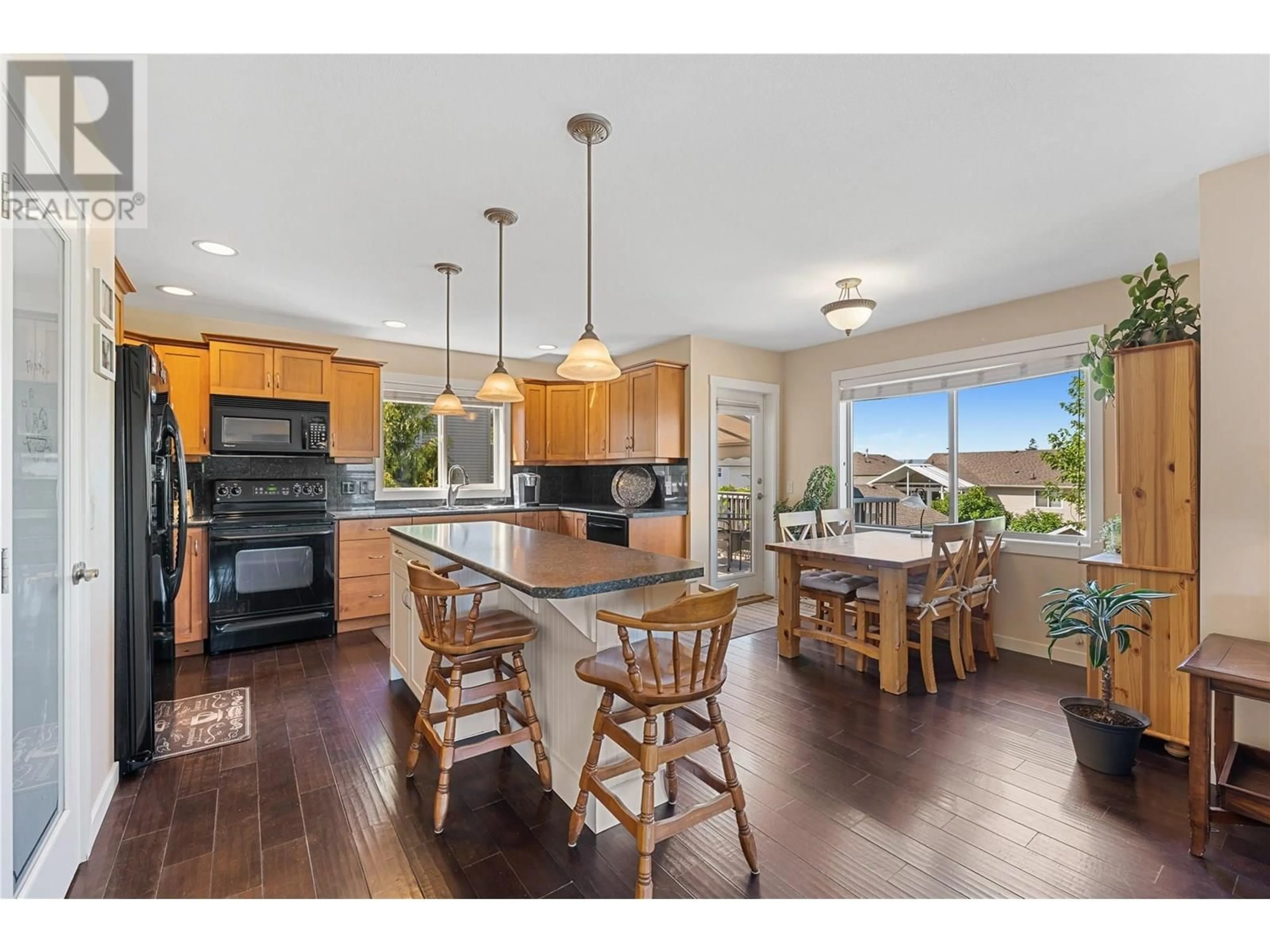 Open concept kitchen, wood/laminate floor for 194 POONIAN COURT, Kelowna British Columbia V1X7Y3