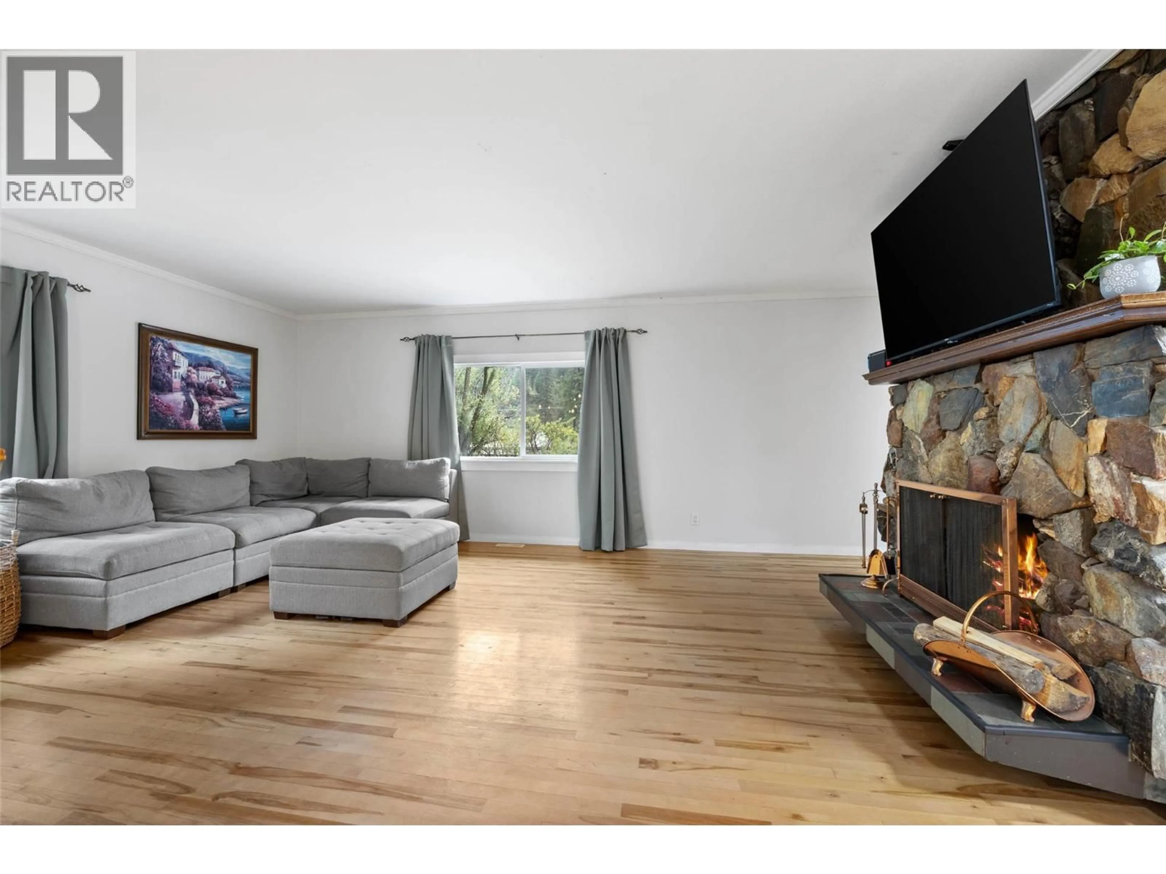 Living room with furniture, wood/laminate floor for 268 MCLURE FERRY ROAD, Kamloops British Columbia V0E2H0