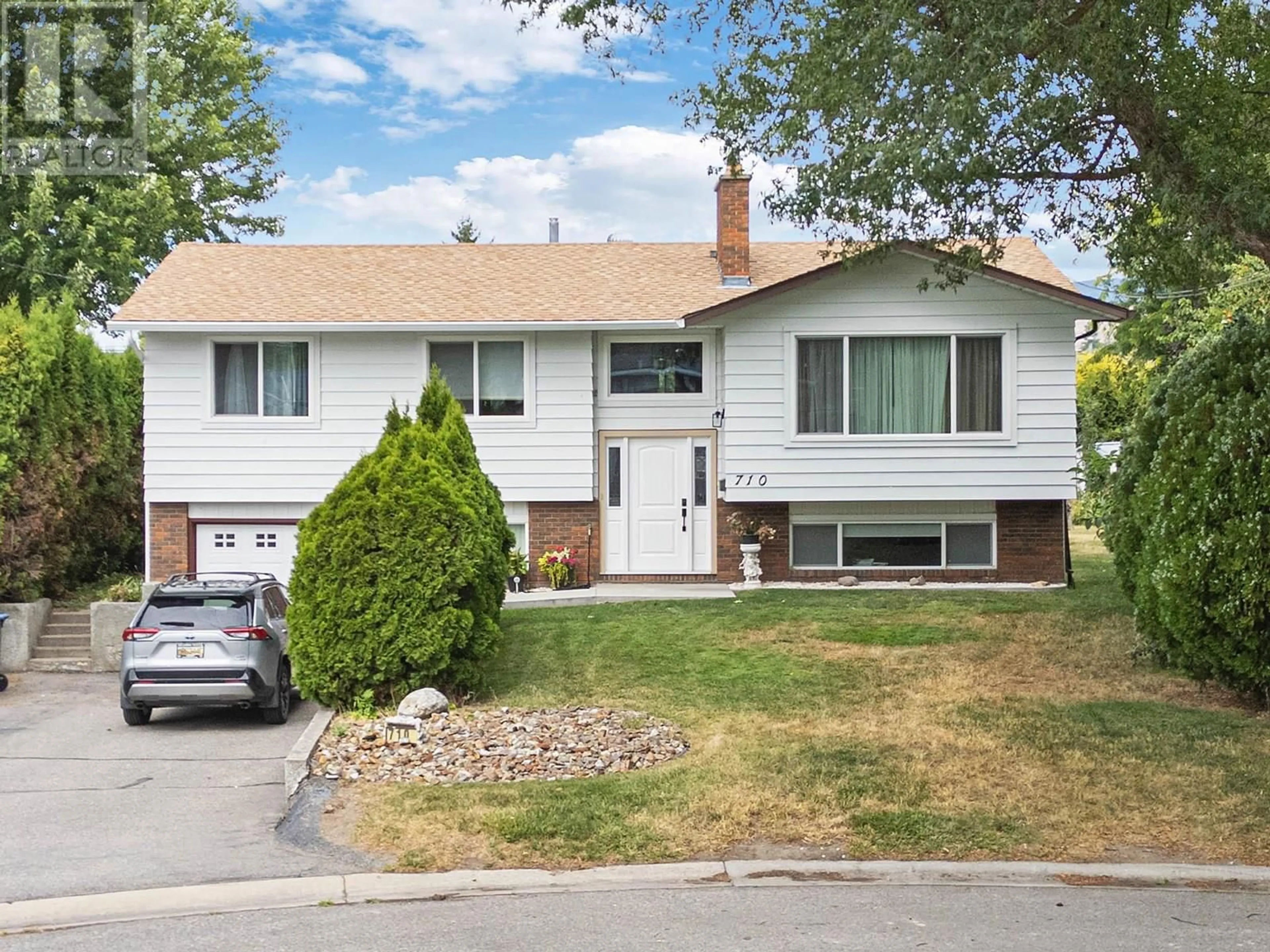 Home with vinyl exterior material, street for 710 TAMARACK DRIVE, Kelowna British Columbia V1X5L9
