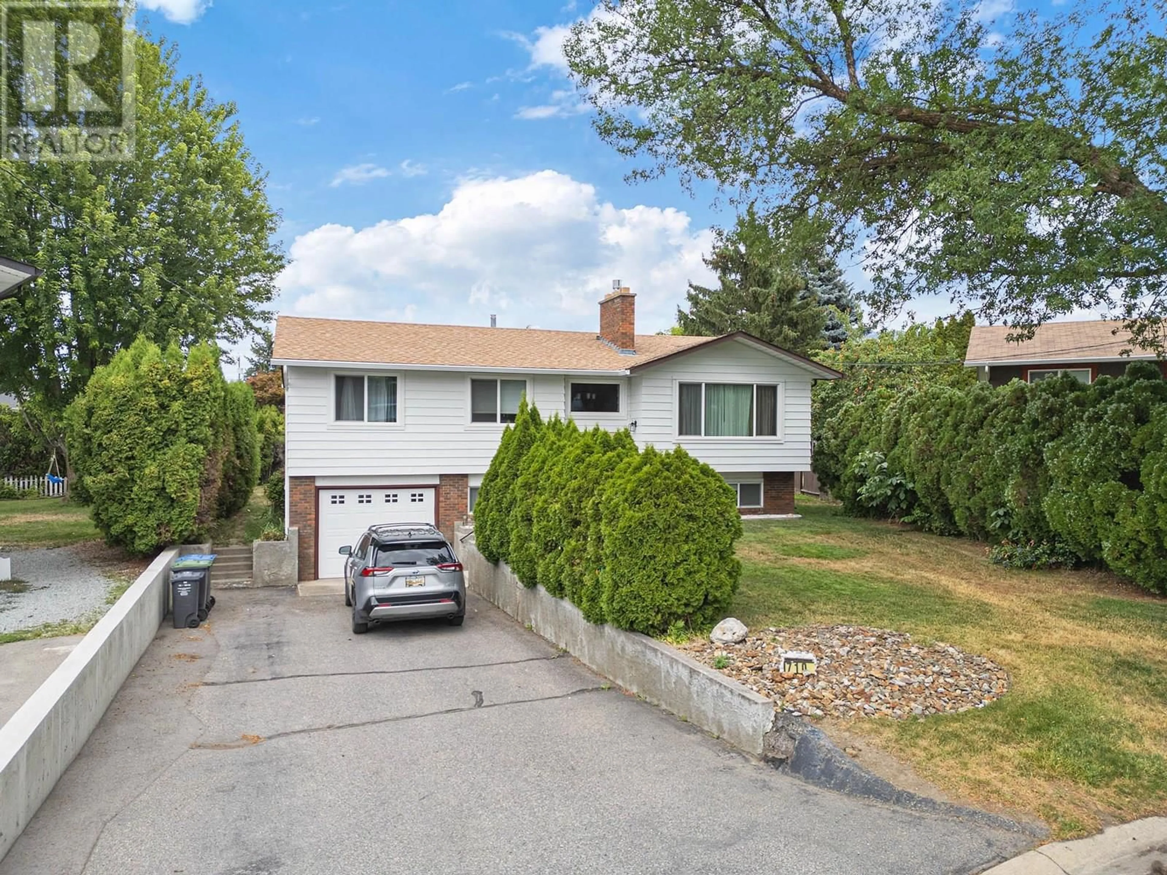 Home with vinyl exterior material, street for 710 TAMARACK DRIVE, Kelowna British Columbia V1X5L9