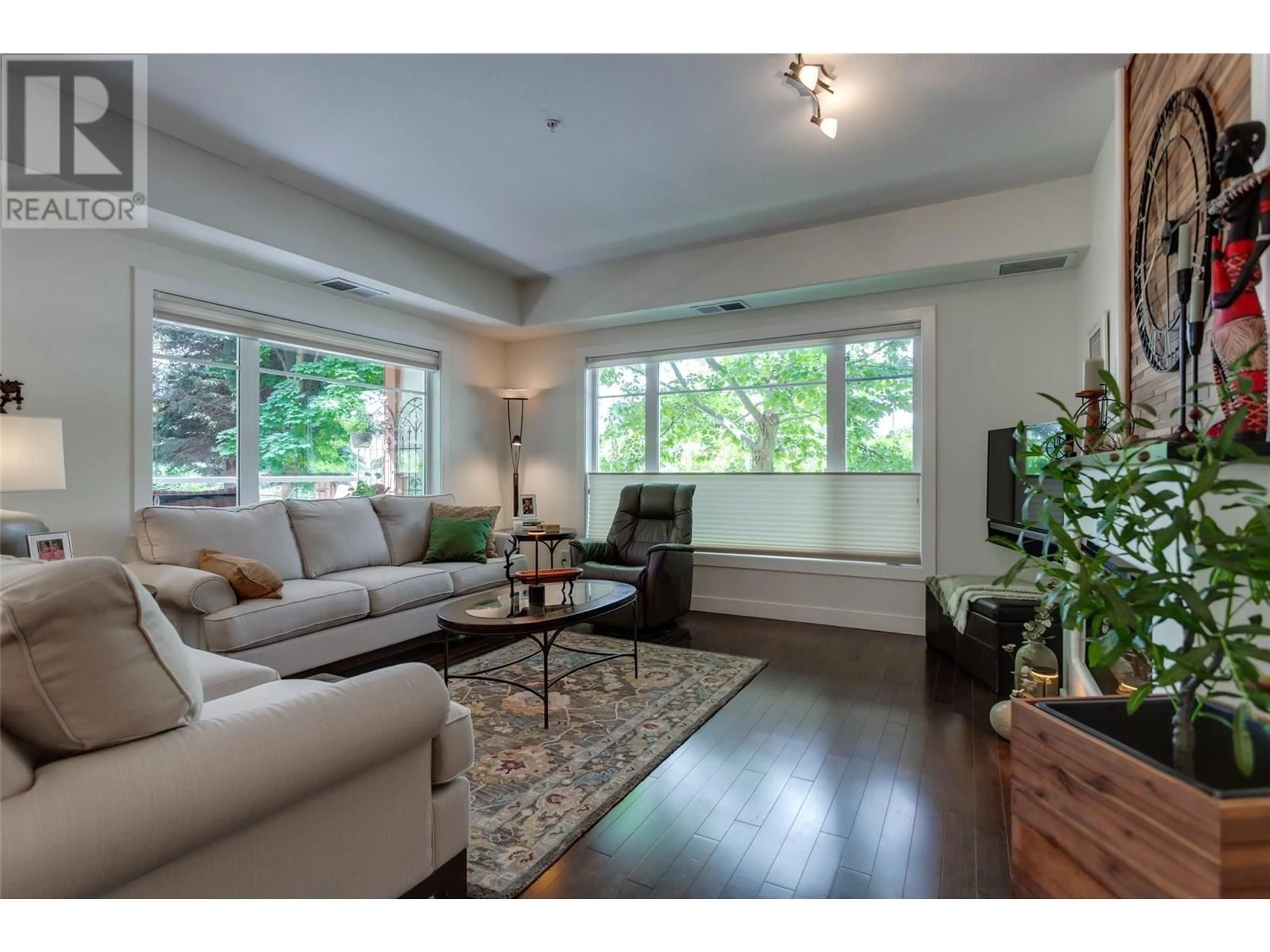 Living room with furniture, wood/laminate floor for 102 - 660 LEQUIME ROAD, Kelowna British Columbia V1W1A4