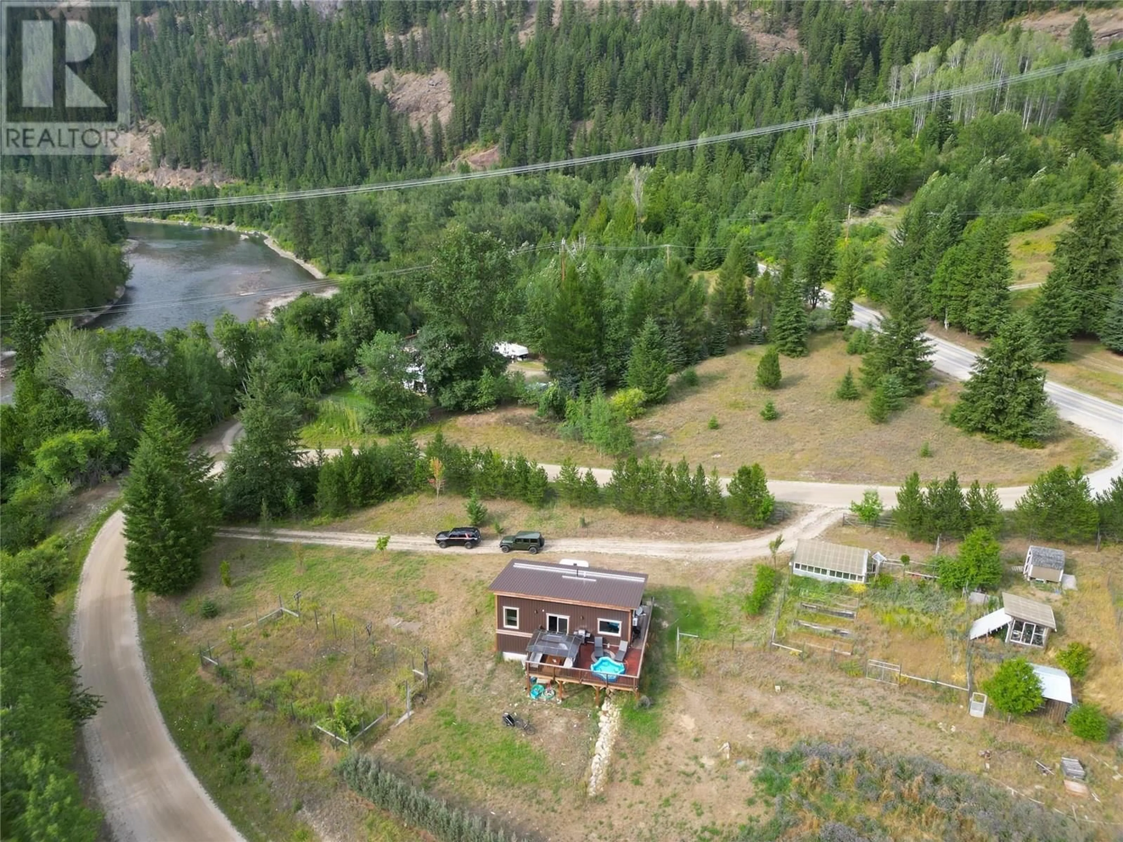 A pic from outside/outdoor area/front of a property/back of a property/a pic from drone, forest/trees view for 3364 KOCH SIDING ROAD, Slocan Park British Columbia V0G2E0