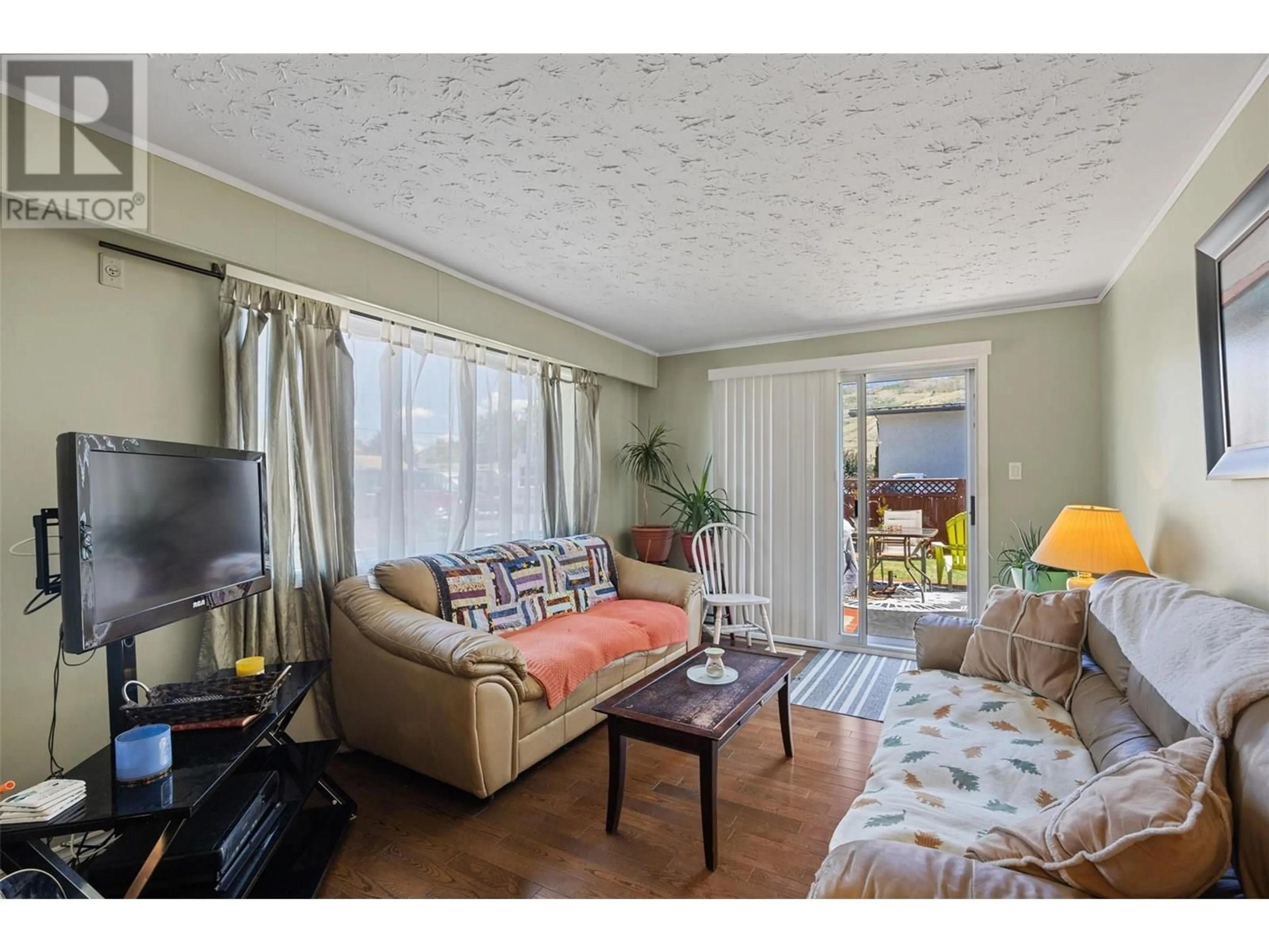 Living room with furniture, wood/laminate floor for 835 PINE SPRINGS ROAD, Kamloops British Columbia V2B6R3