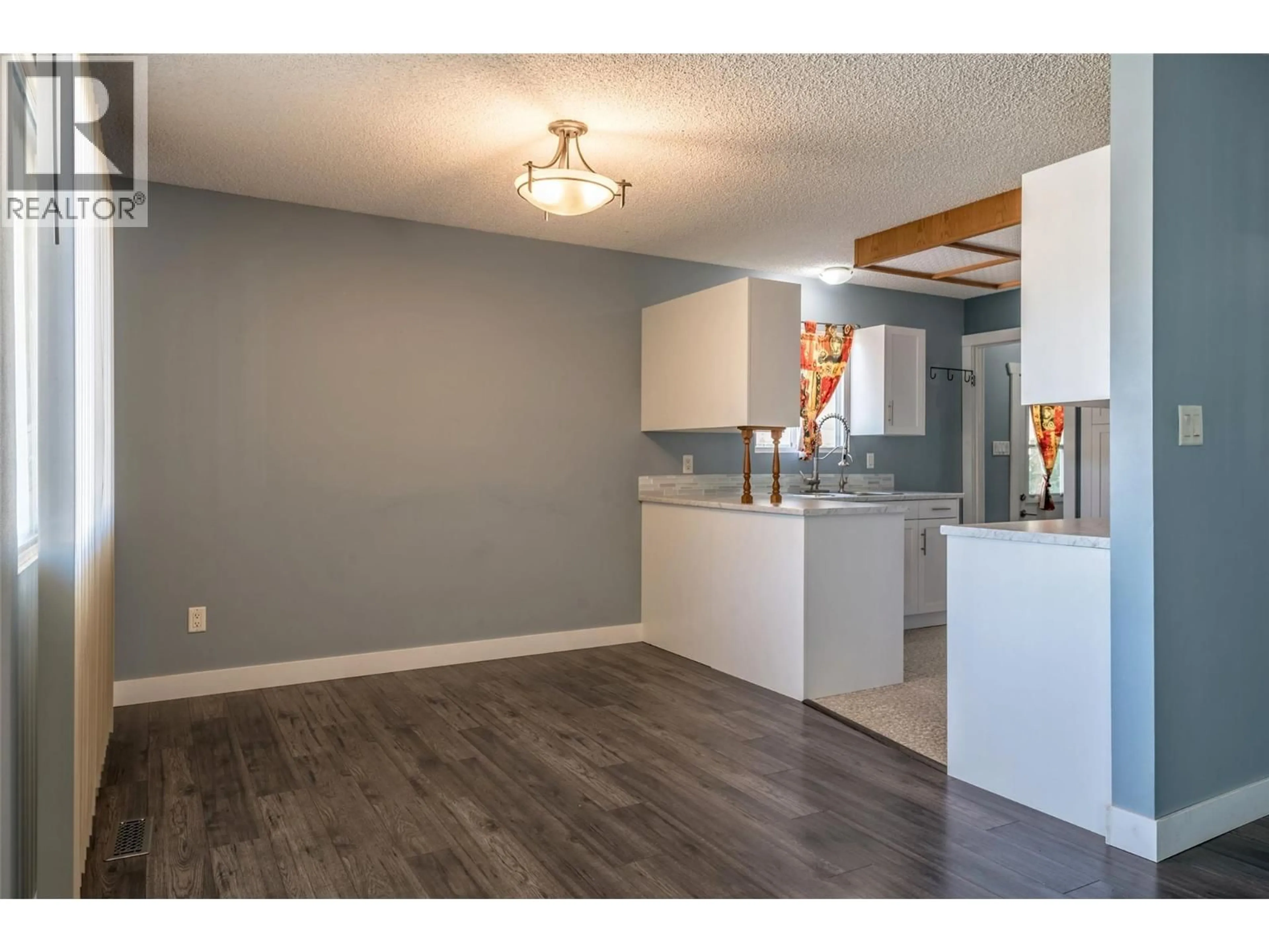 Open concept kitchen, wood/laminate floor for 3704 40 AVENUE, Vernon British Columbia V1T7E6