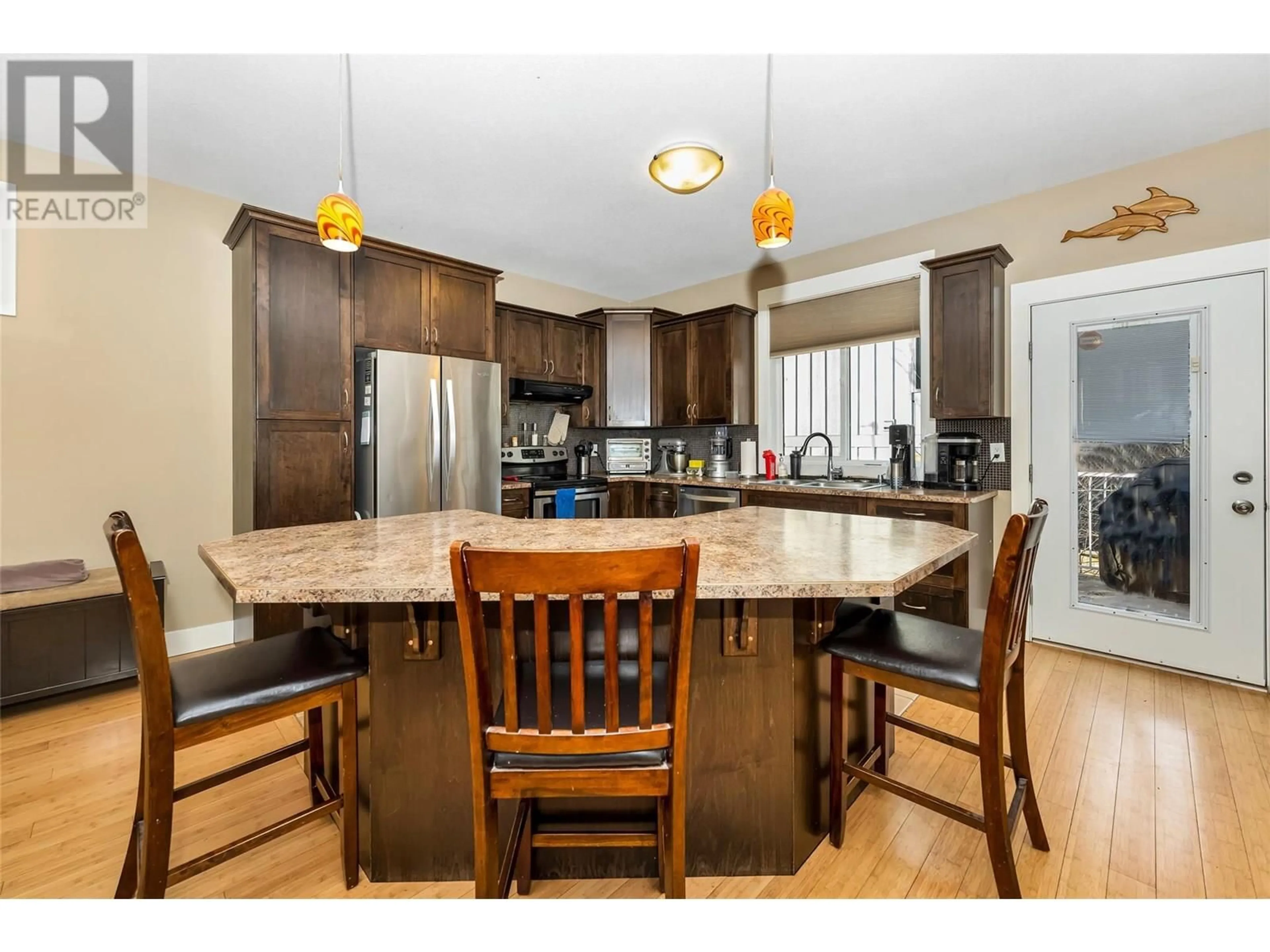 Open concept kitchen, wood/laminate floor for 4406A 25TH STREET, Vernon British Columbia V1T4S6