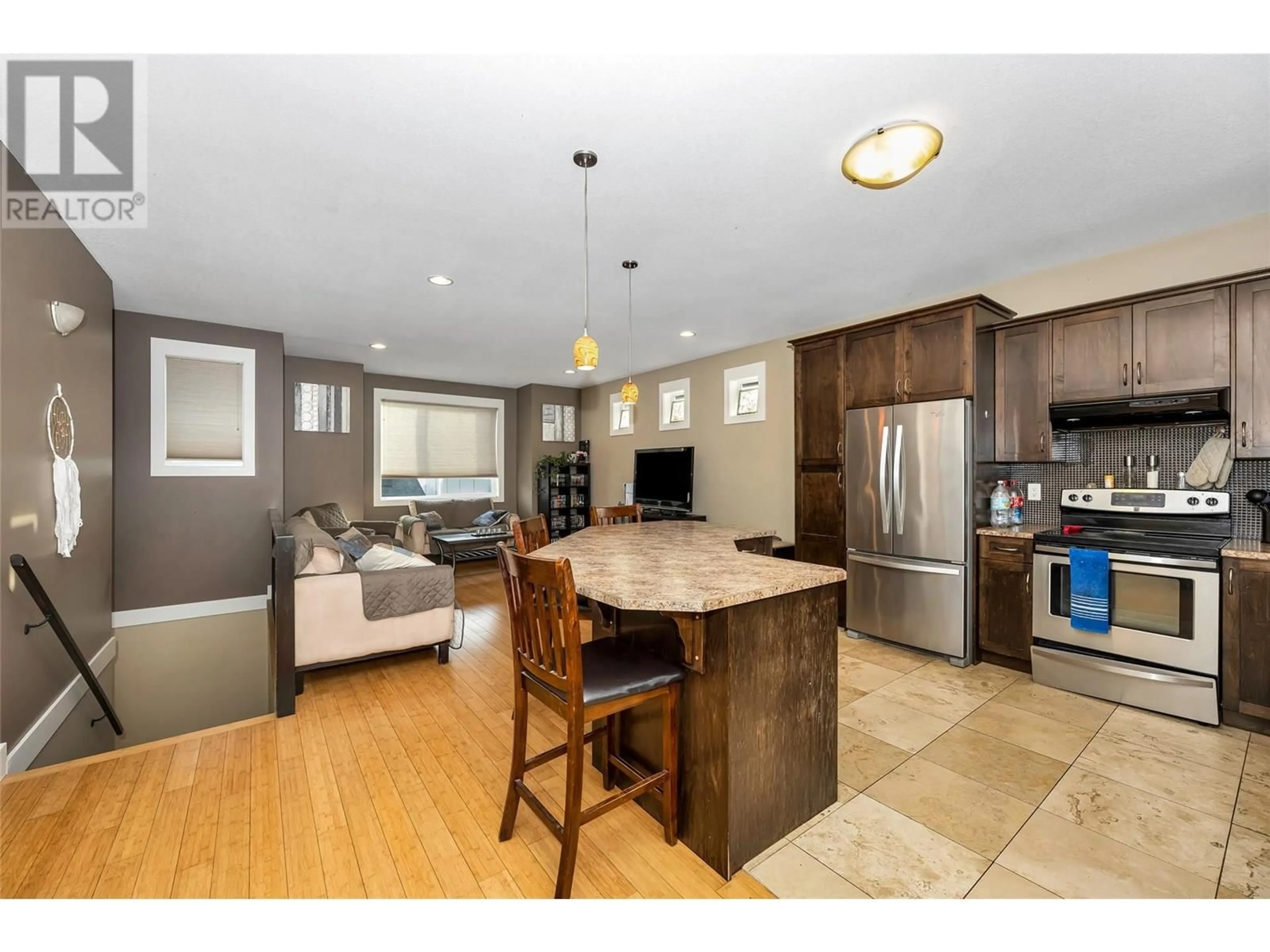 Open concept kitchen, wood/laminate floor for 4406A 25TH STREET, Vernon British Columbia V1T4S6