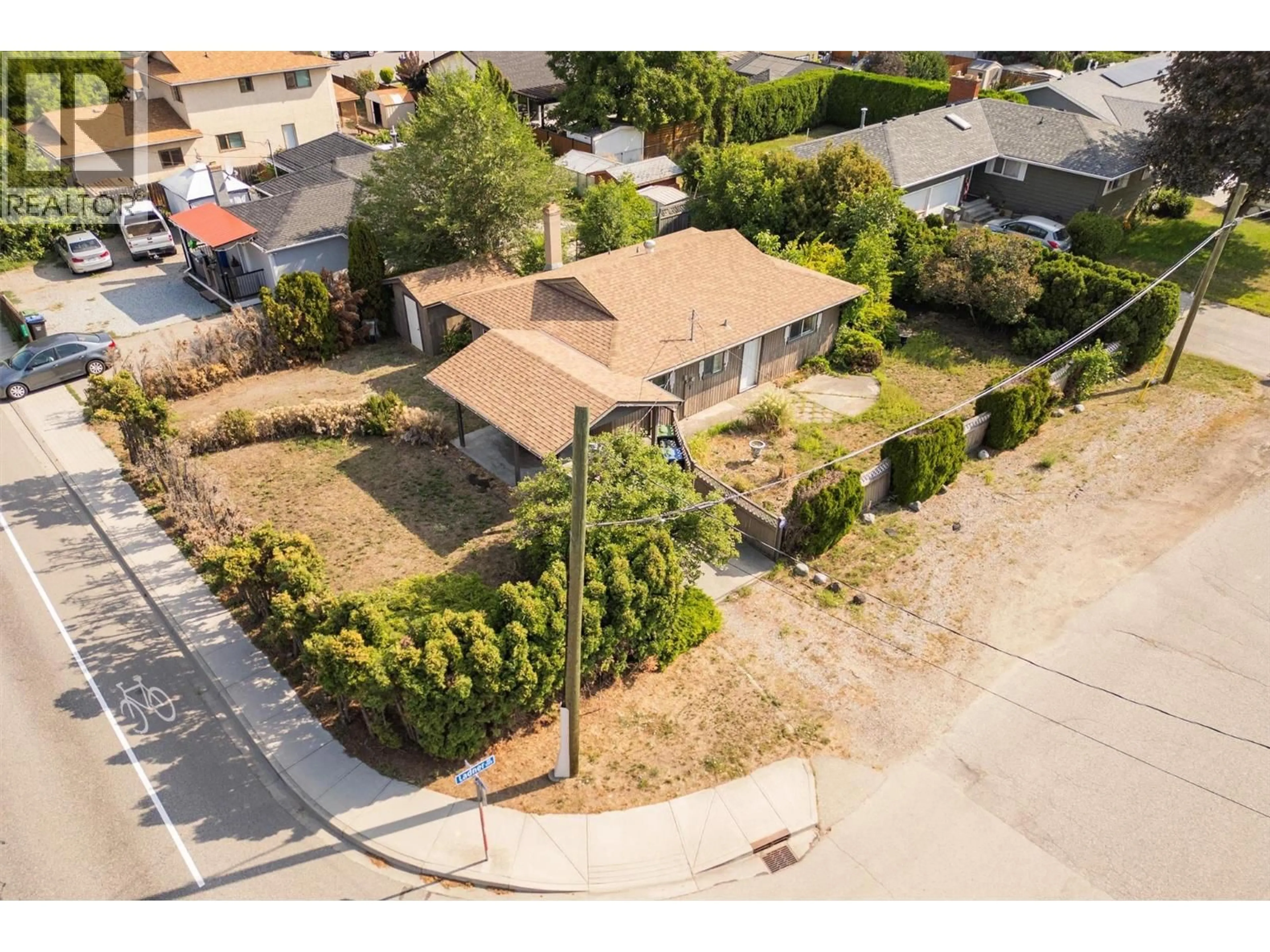 A pic from outside/outdoor area/front of a property/back of a property/a pic from drone, street for 1220 LADNER ROAD, Kelowna British Columbia V1W3M8
