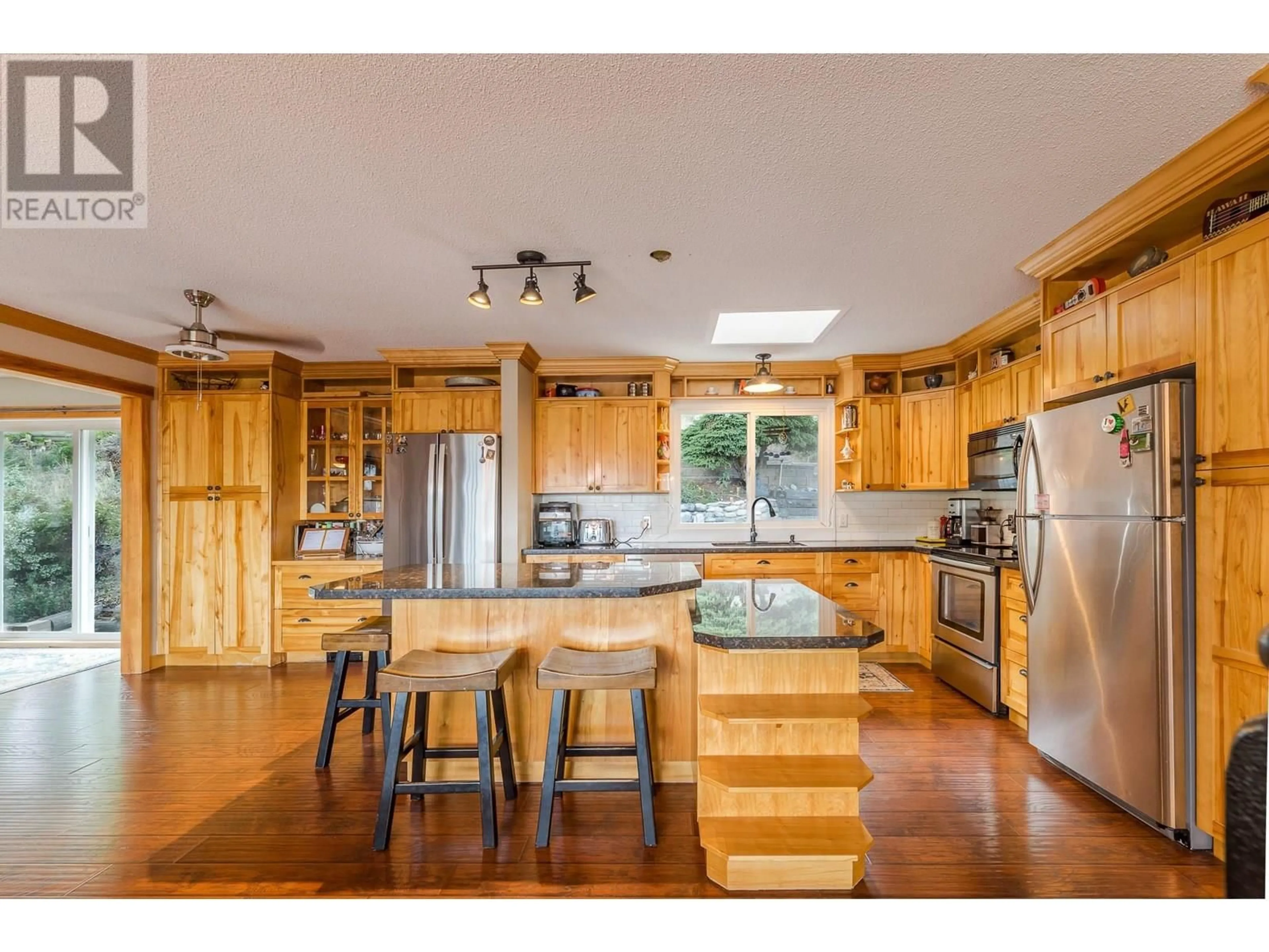 Open concept kitchen, wood/laminate floor for 12620 REYNOLDS AVENUE, Summerland British Columbia V0H1Z8