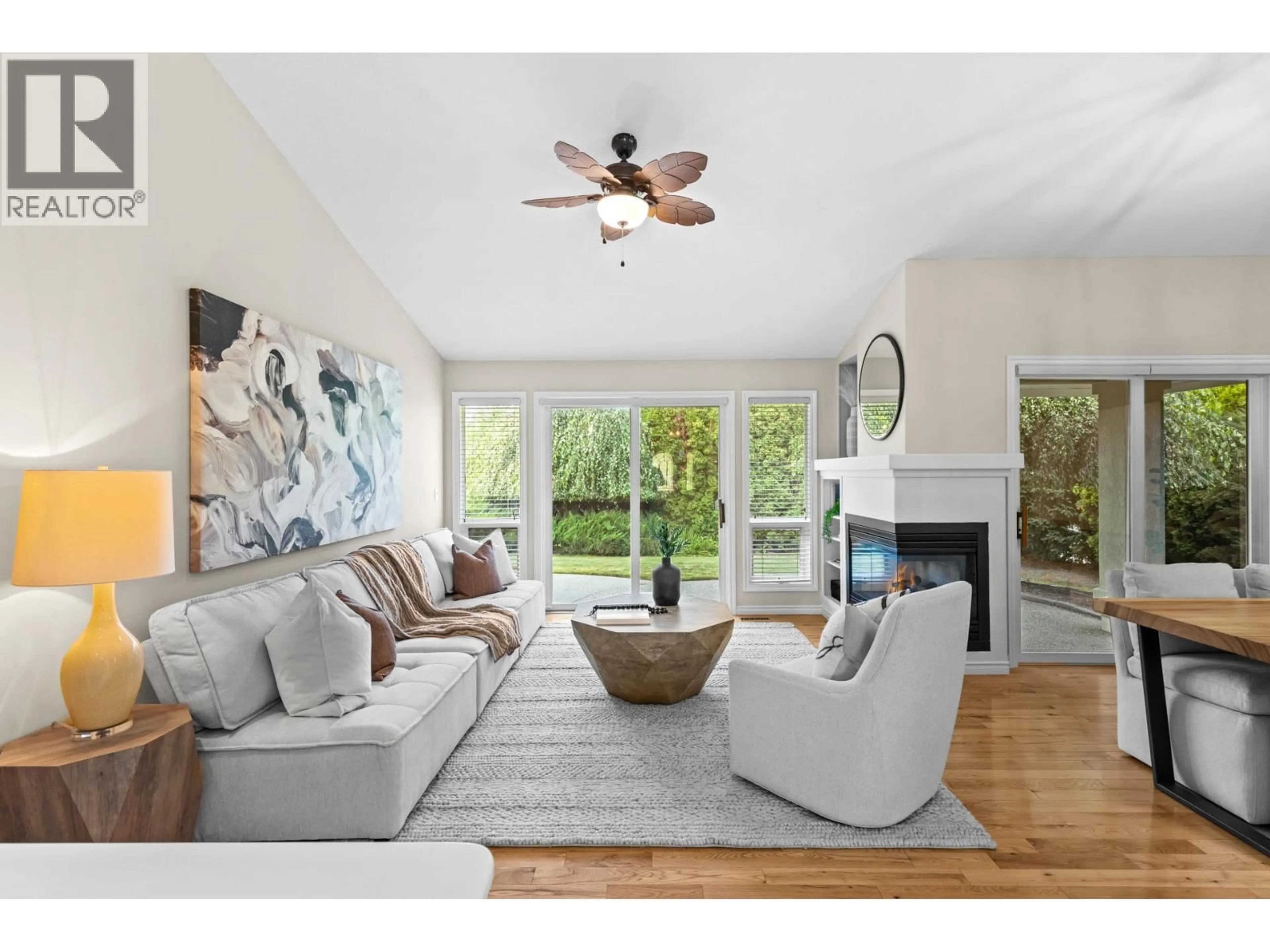Living room with furniture, wood/laminate floor for 4140 GALLAGHERS CROSSWAY, Kelowna British Columbia V1W3Z9