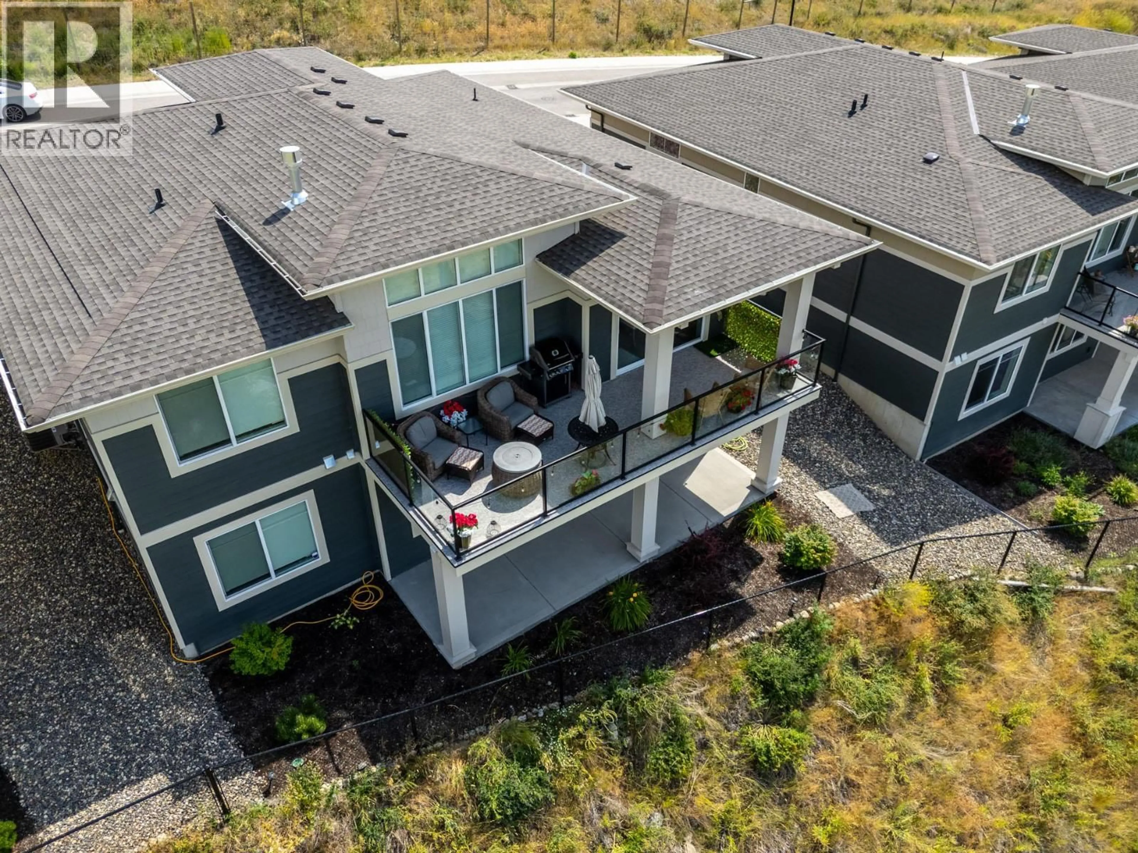 A pic from outside/outdoor area/front of a property/back of a property/a pic from drone, mountain view for 1396 TOWER RANCH DRIVE, Kelowna British Columbia V1P1T8