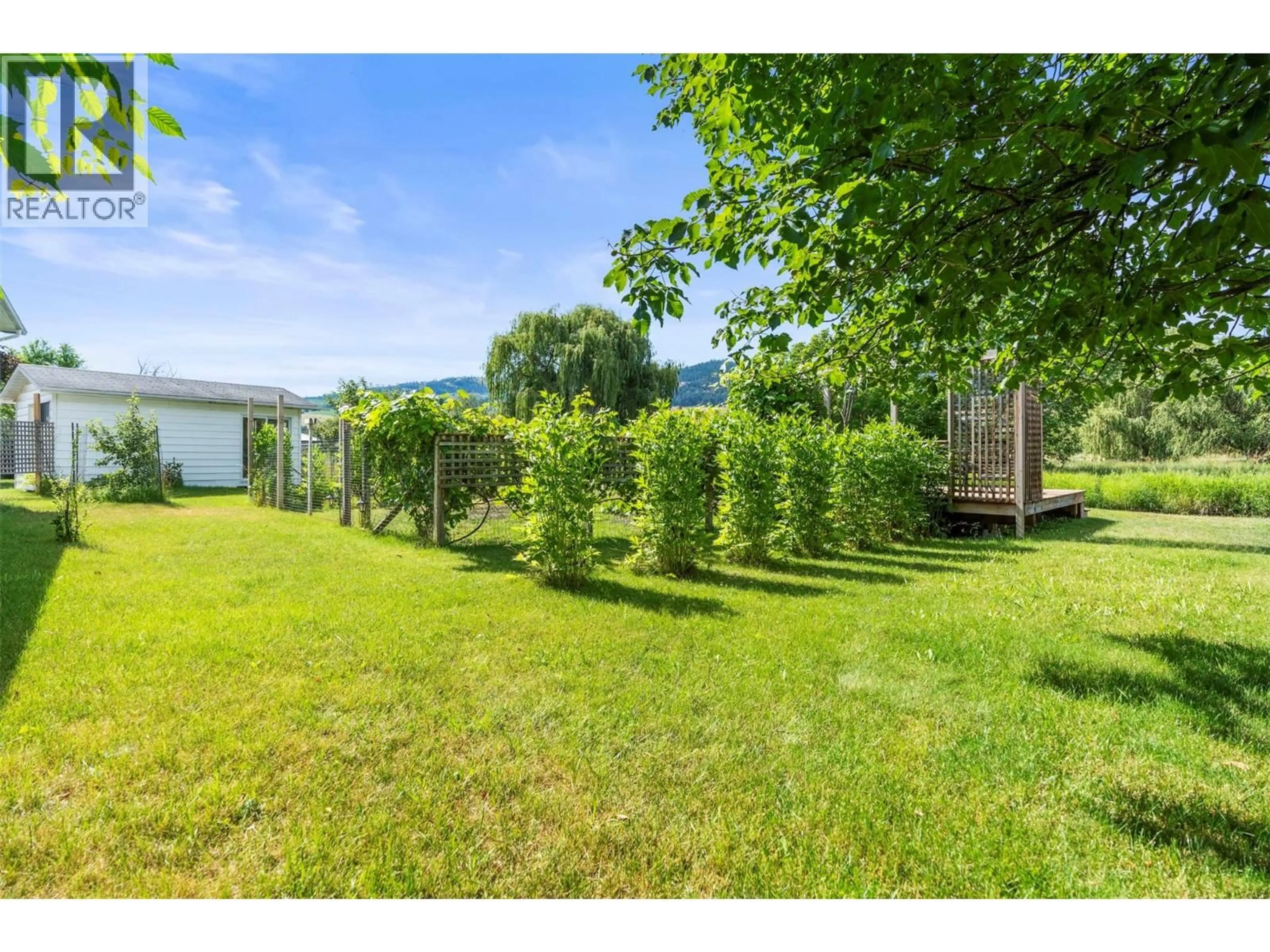 A pic from outside/outdoor area/front of a property/back of a property/a pic from drone, forest/trees view for 101 - 2727 LAKESHORE ROAD, Vernon British Columbia V1H1X5