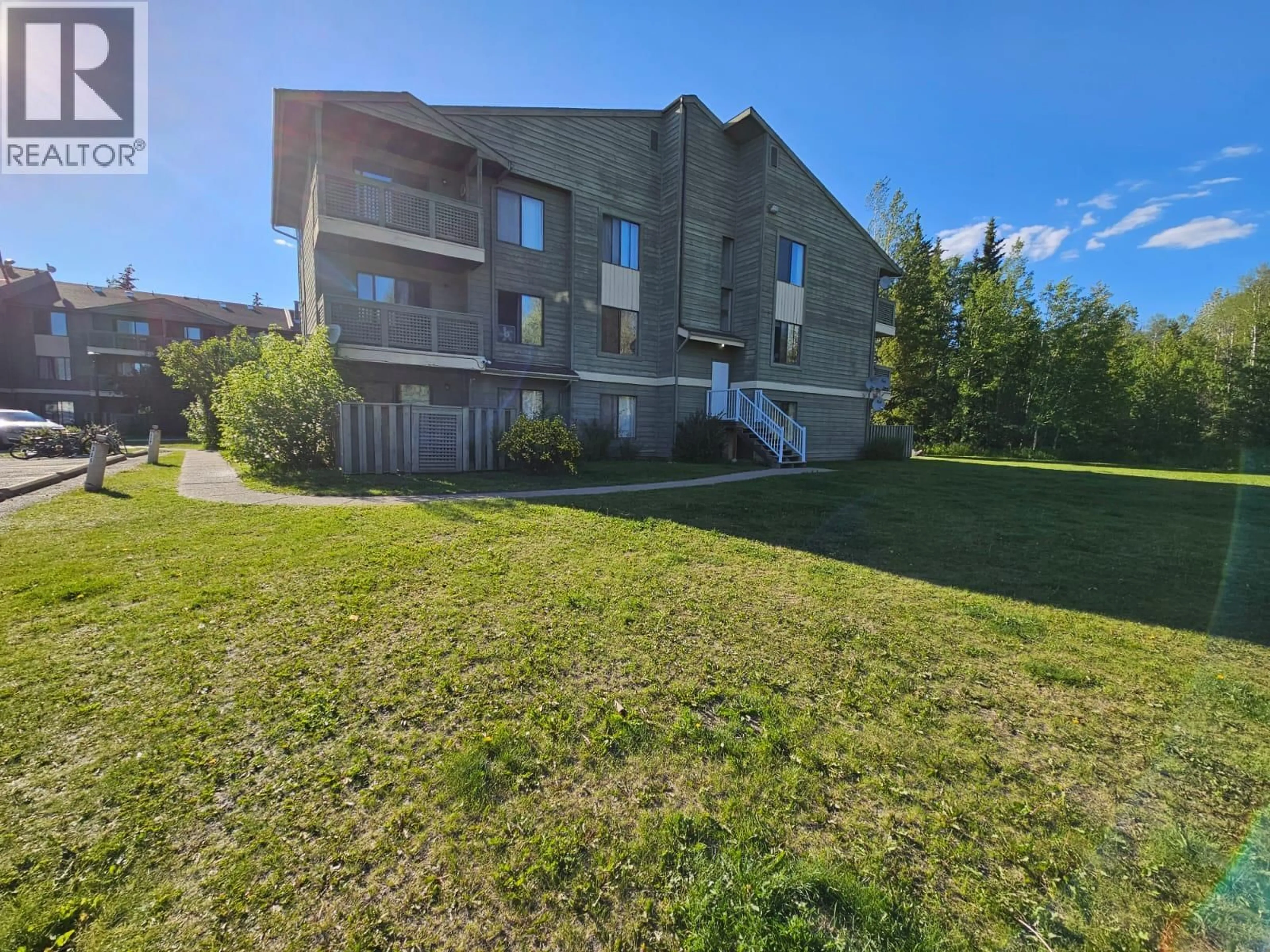 A pic from outside/outdoor area/front of a property/back of a property/a pic from drone, building for 201 - 185 CHAMBERLAIN CRESCENT, Tumbler Ridge British Columbia V0C2W0