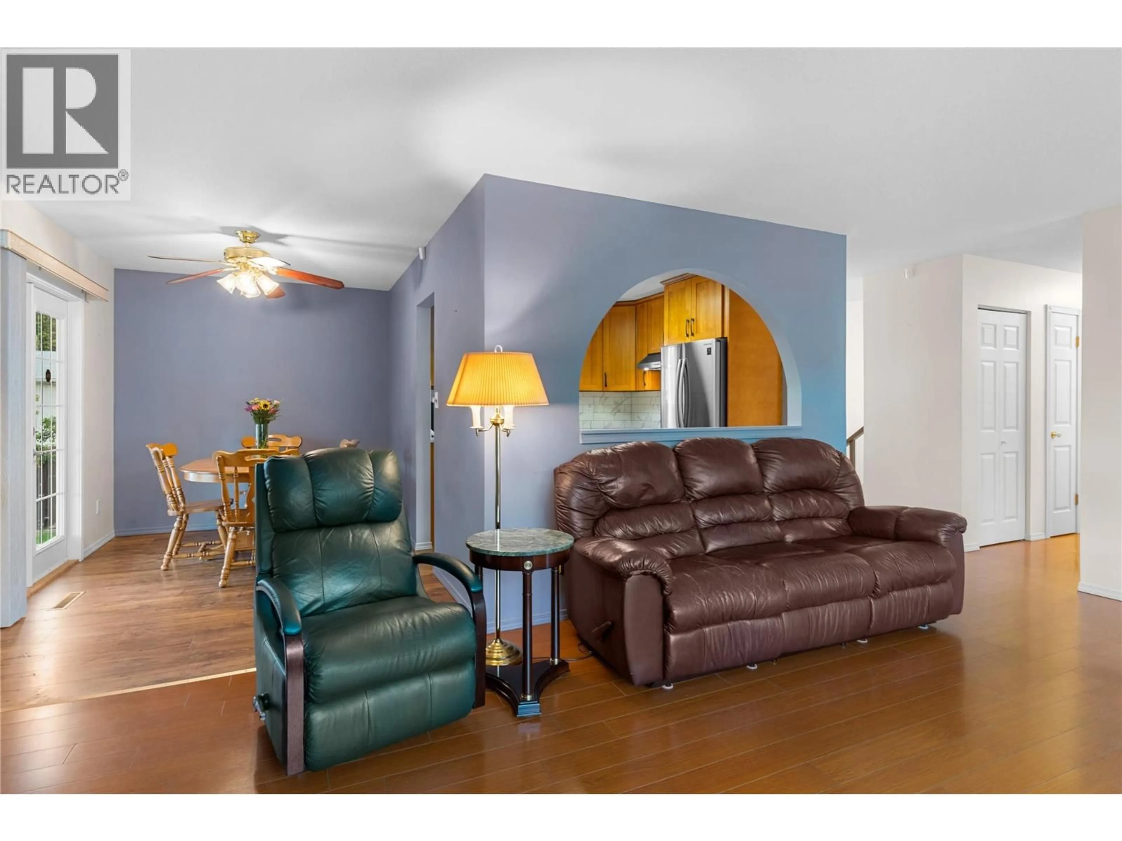 Living room with furniture, wood/laminate floor for 1390 CREEKSIDE ROAD, Kelowna British Columbia V1X1B4